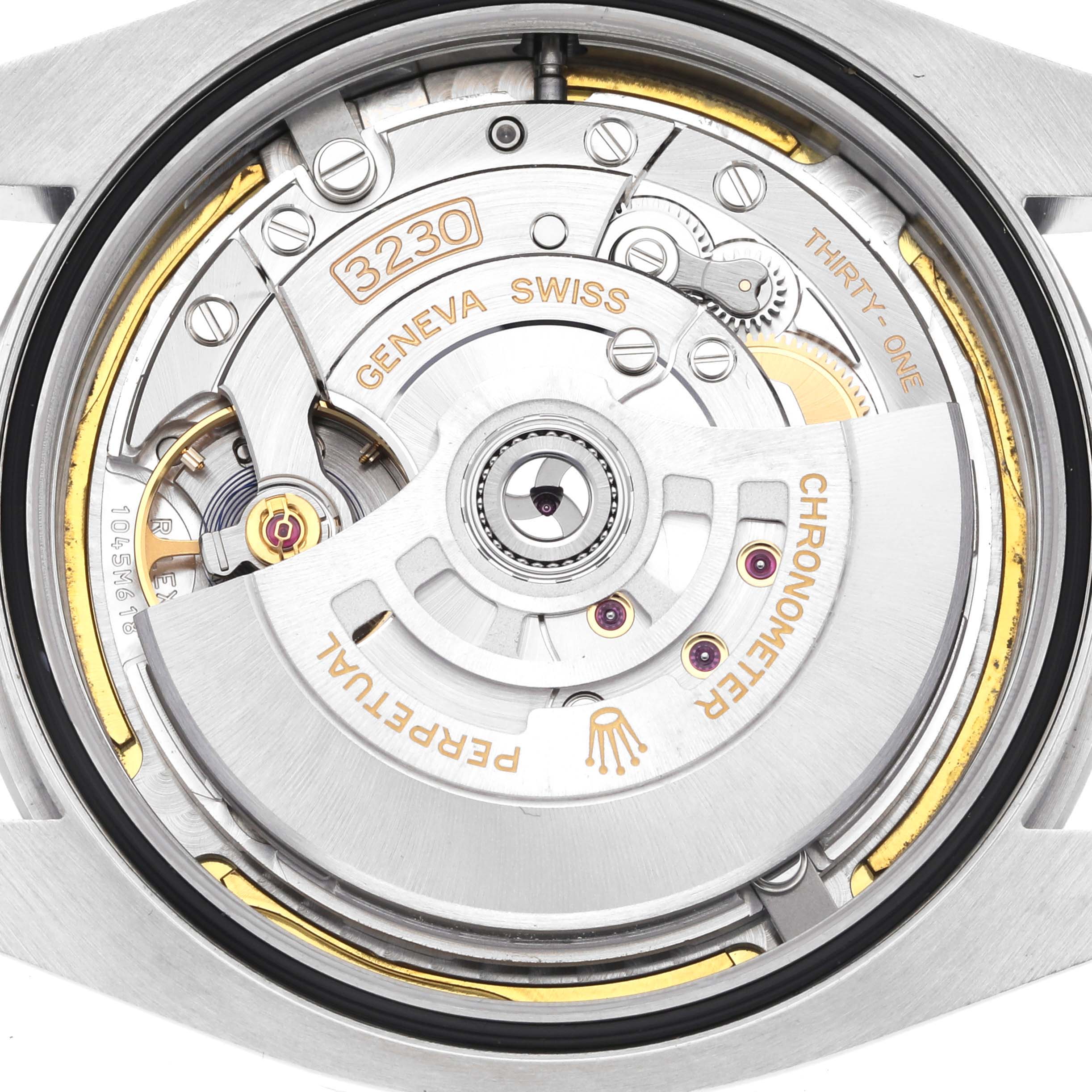 The image shows a close-up of the Rolex Air-King 126900 Men's Stainless Steel Black Dial 126900 Men's Stainless Steel Black Dial's movement from the back, highlighting its intricate mechanical parts.