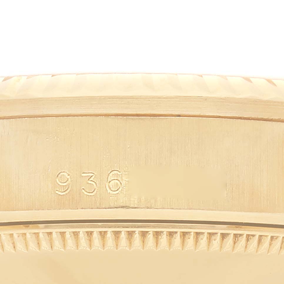 The image shows a close-up of the side and bezel of the Rolex President 68278 Women
s Yellow Gold White Dial 68278 Women
s Yellow Gold White Dial model watch, displaying part of its serial number.