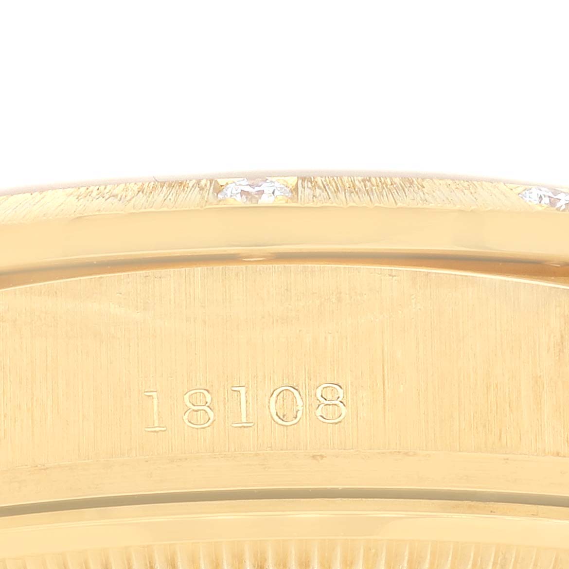 This close-up image shows the side engraving of the Rolex President 18108 Men
s Yellow Gold Champagne Dial 18108 Men
s Yellow Gold Champagne Dial model watch with the model number "18108."
