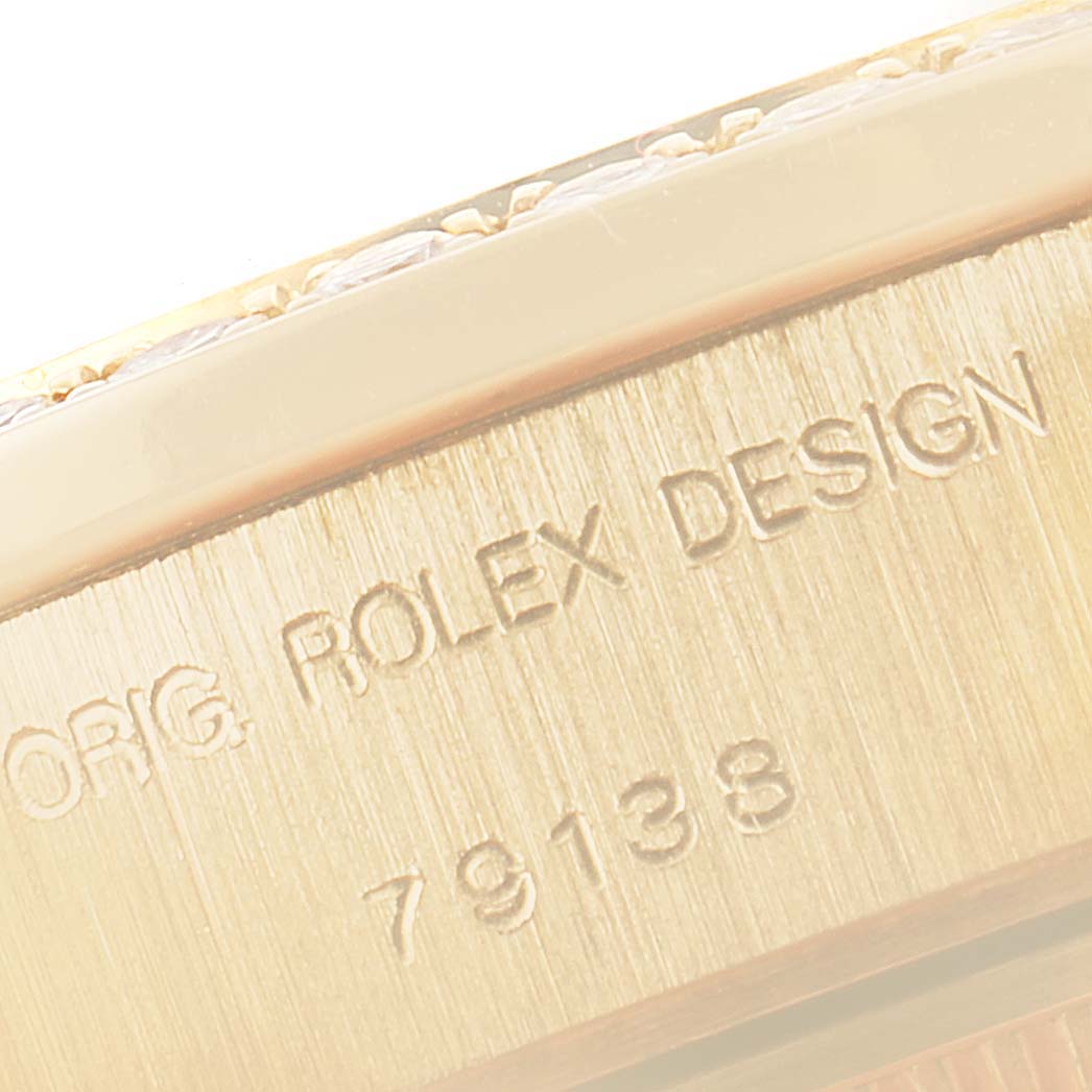 This close-up image shows the engraved model number "79138" and "ORIG. ROLEX DESIGN" on the bracelet of a Rolex President 79138 Women
s Yellow Gold Mother of Pearl Dial 79138 Women
s Yellow Gold Mother of Pearl Dial watch.