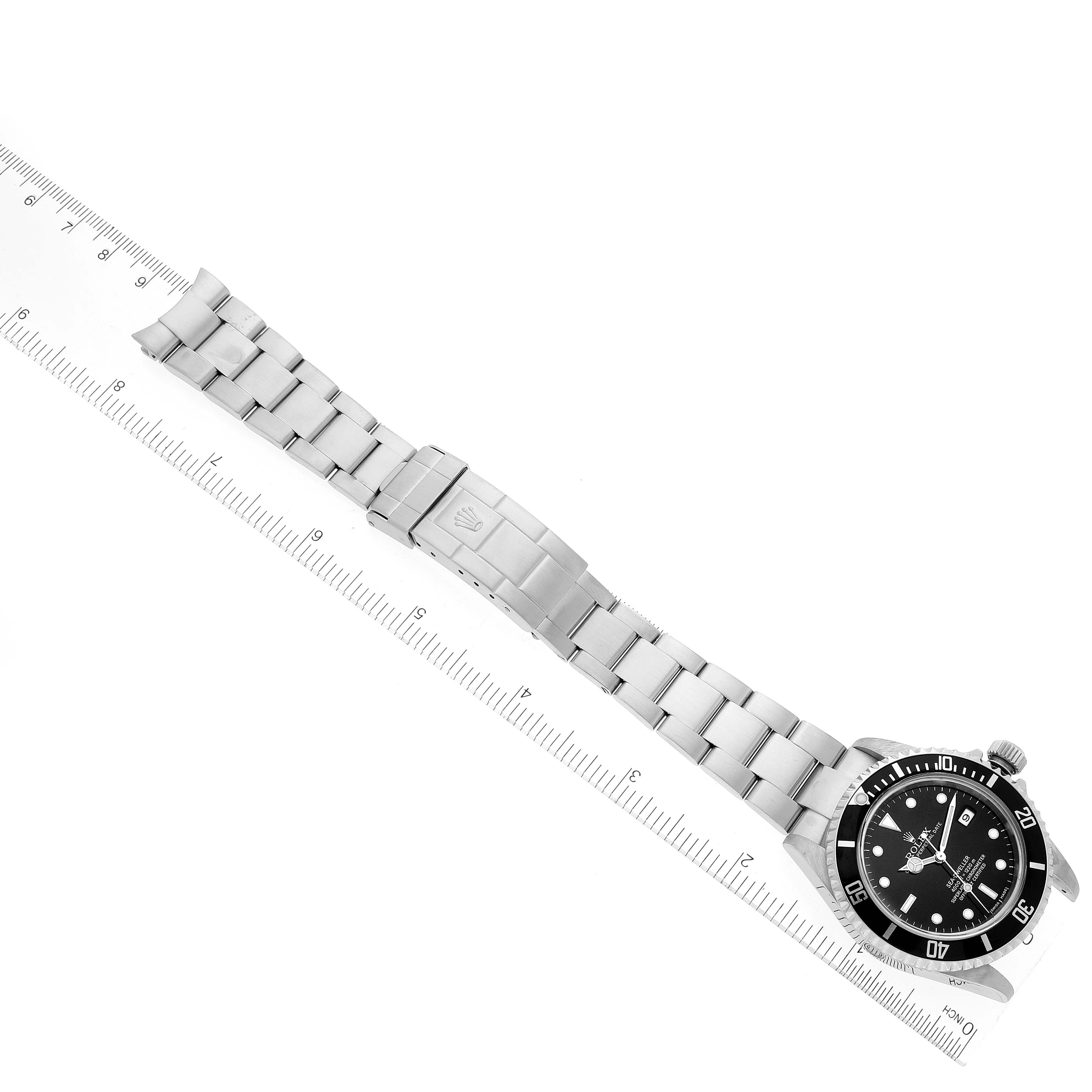 This image shows a top-down view of a Rolex Sea-Dweller 16600T Men's Stainless Steel Black Dial 16600T Men's Stainless Steel Black Dial watch, including the bracelet, clasp, and face positioned next to a ruler.