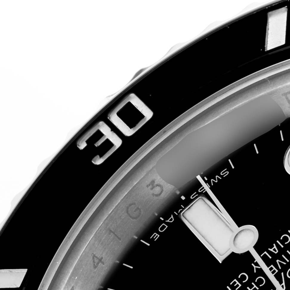 The image shows a close-up of the bezel and dial of the Rolex Submariner 116610 Men's Stainless Steel Black Dial, highlighting the 30-minute mark.
