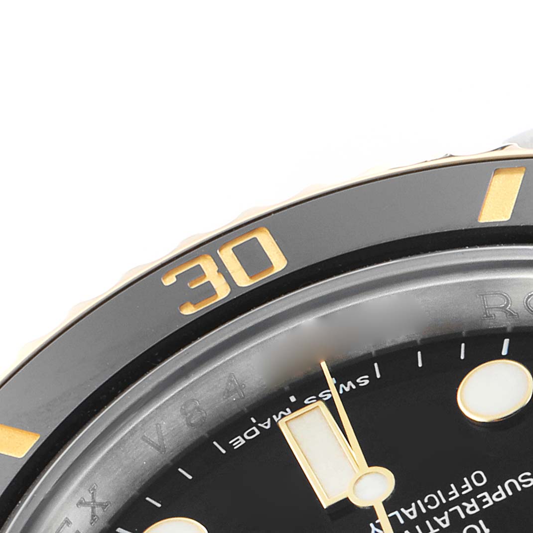 The image shows a close-up of the Rolex Submariner 116613 Men's Steel and Gold (two tone) Black Dial's bezel and partial dial, focusing on the 30-minute mark and hour indicators.