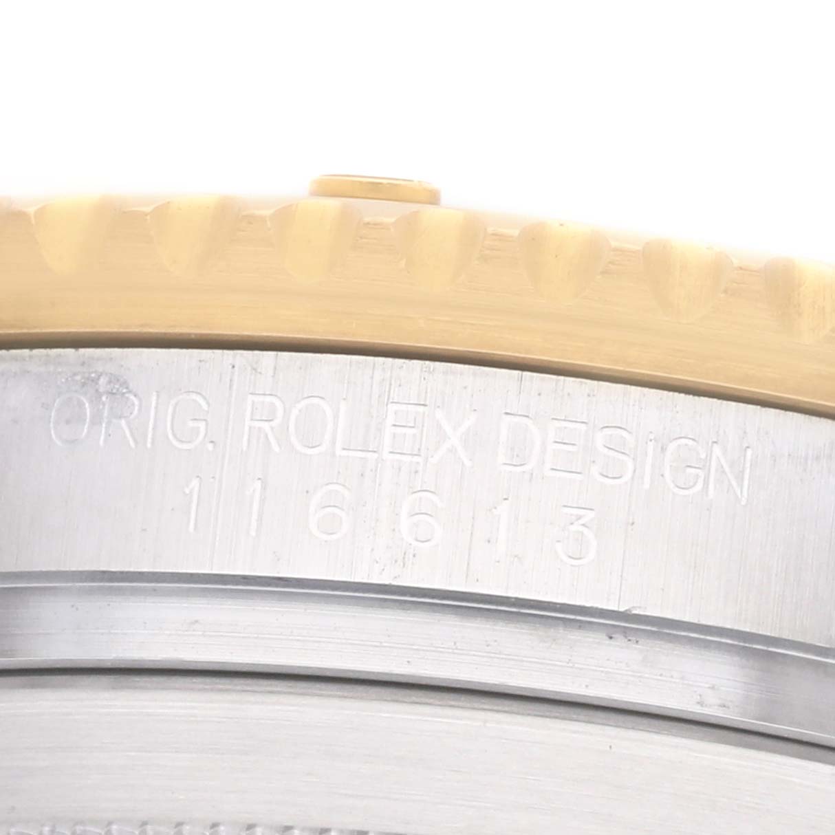 The image shows a close-up of the Rolex Submariner 116613 Men's Steel and Gold (two tone) Black Dial's case, highlighting the engraved model number on the side.