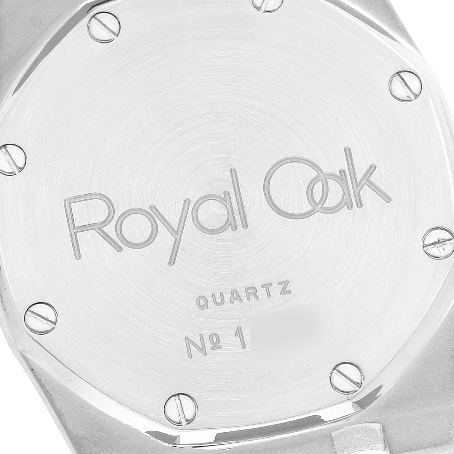 The image shows the case back of an Audemars Piguet Royal Oak 56303SA Men's Steel and Gold (two tone) Beige Dial 56303SA Men's Steel and Gold (two tone) Beige Dial watch engraved with "Royal Oak" and "QUARTZ".