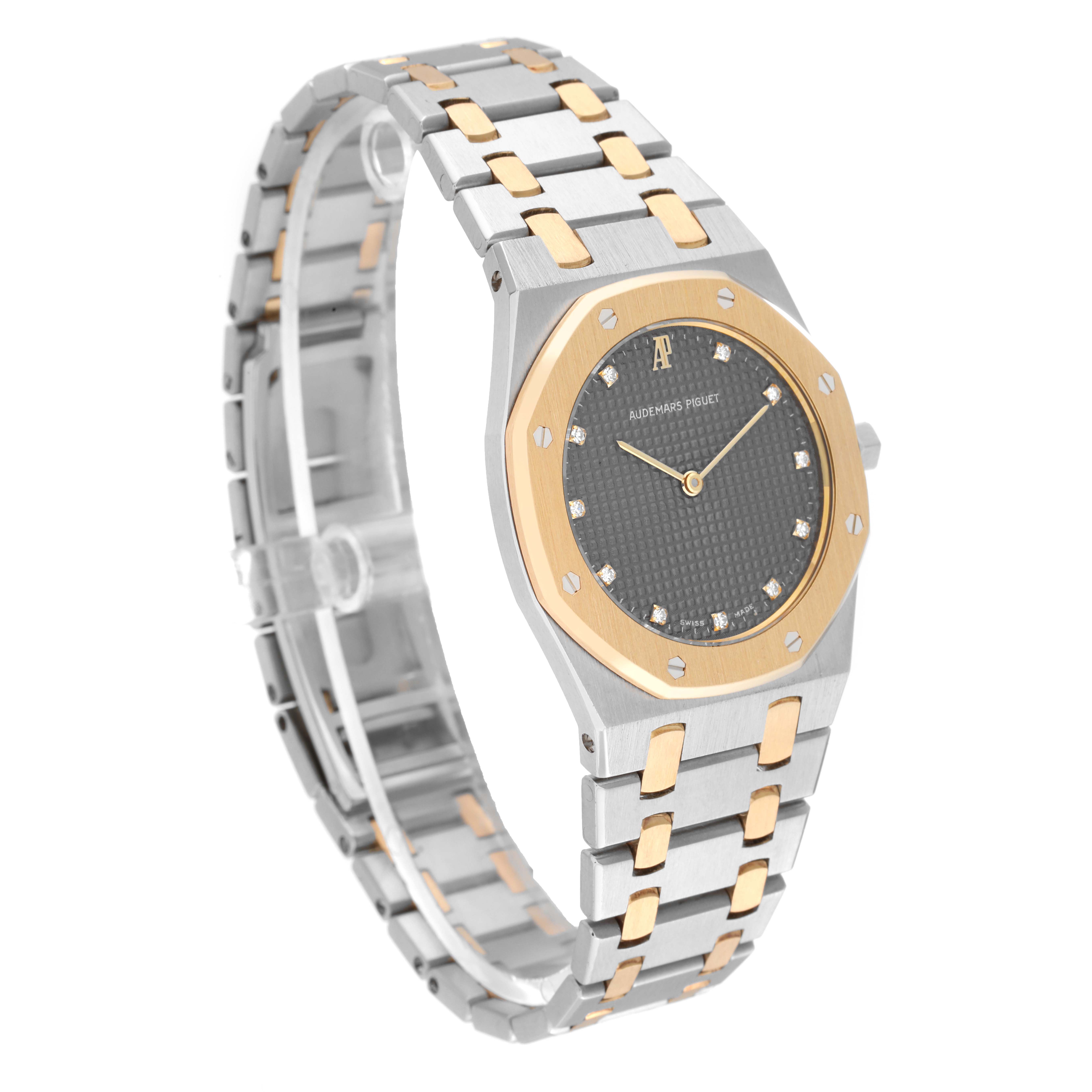 This image shows a Royal Oak model by Audemars Piguet, highlighting the watch face, bezel, and two-tone bracelet at an oblique angle.