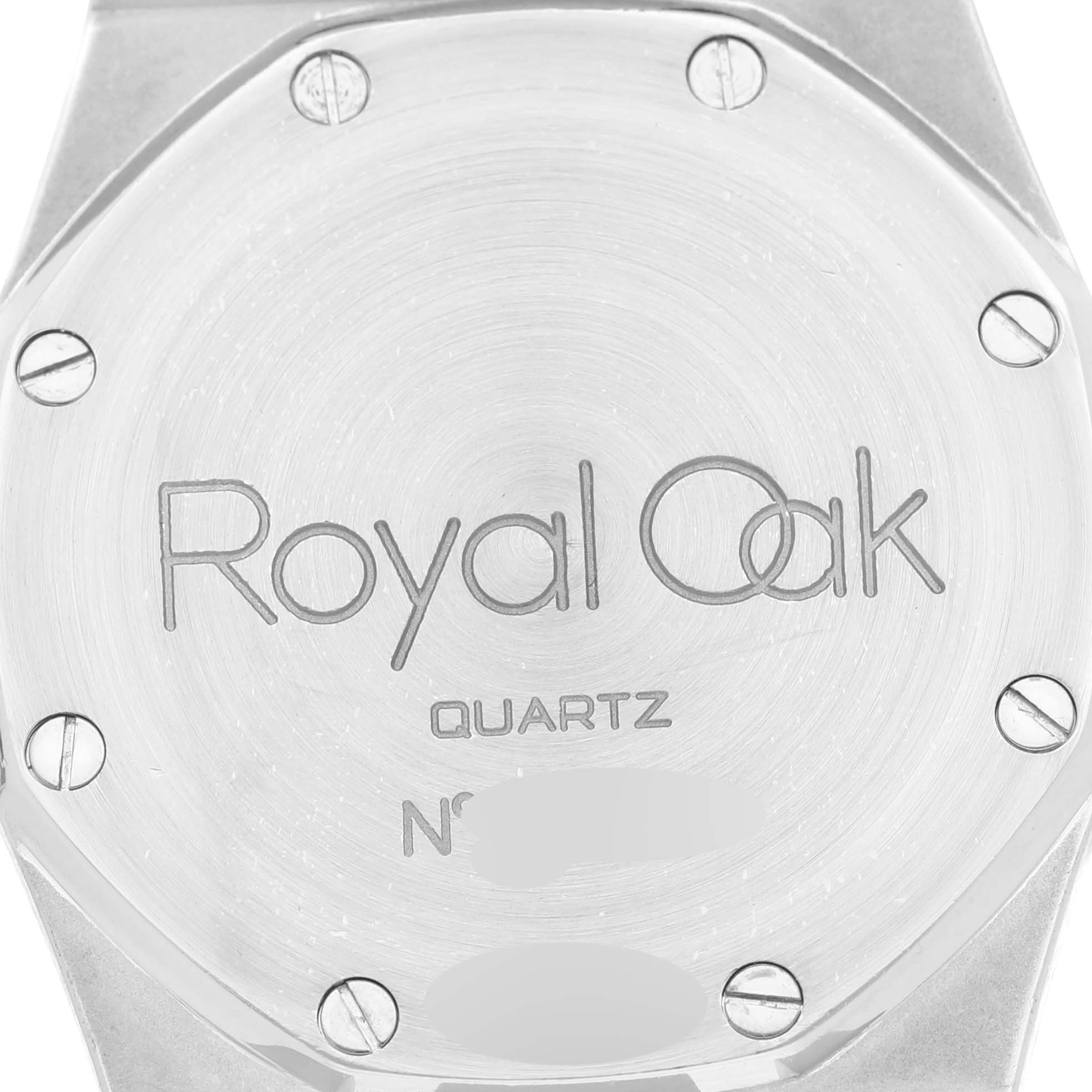 The image shows the case back of a Royal Oak Quartz model by Audemars Piguet, featuring visible screws and engraved text.