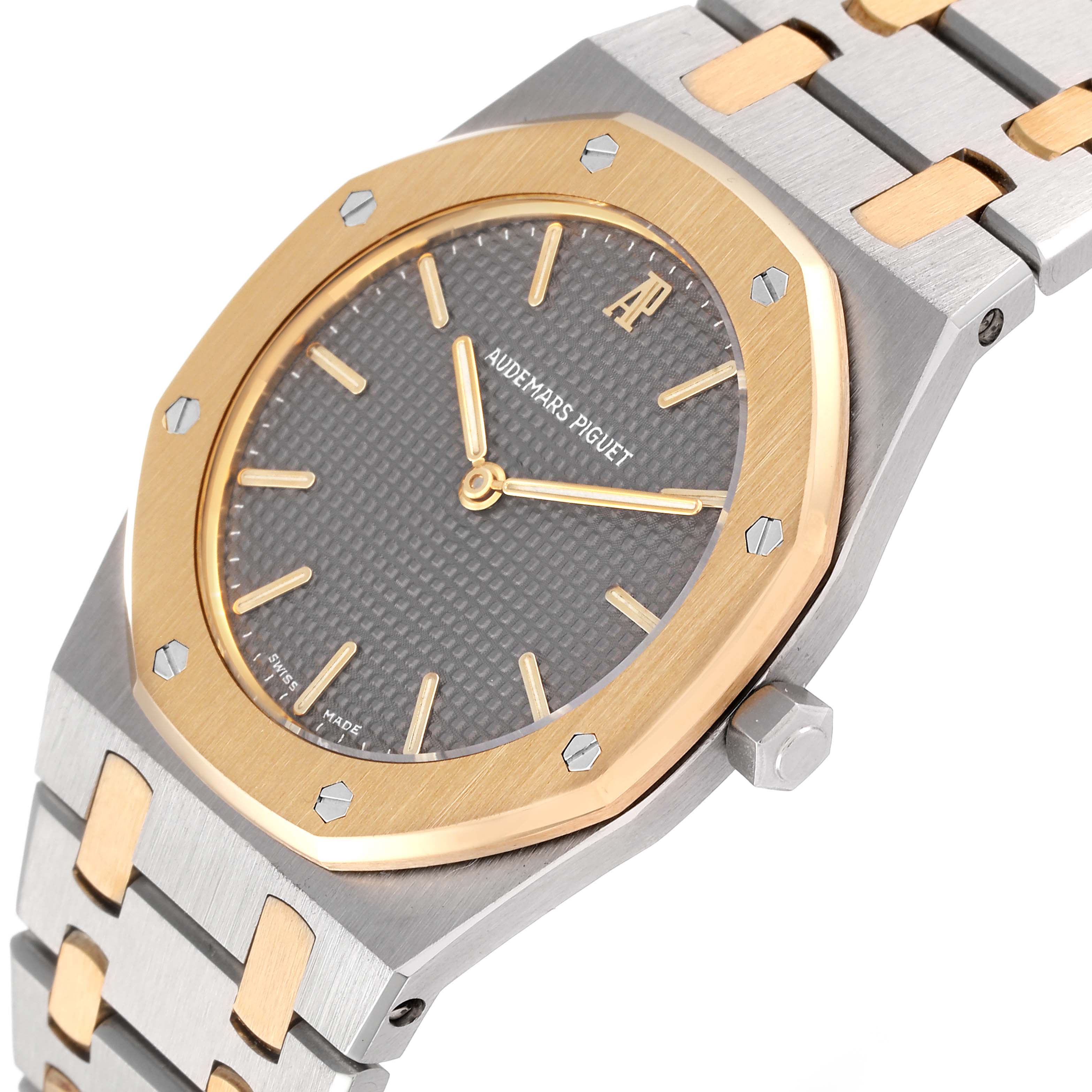 The image shows a close-up view of the dial, bezel, and part of the bracelet of an Audemars Piguet Royal Oak 56303SA Men's Steel and Gold (two tone) Grey Dial 56303SA Men's Steel and Gold (two tone) Grey Dial watch.
