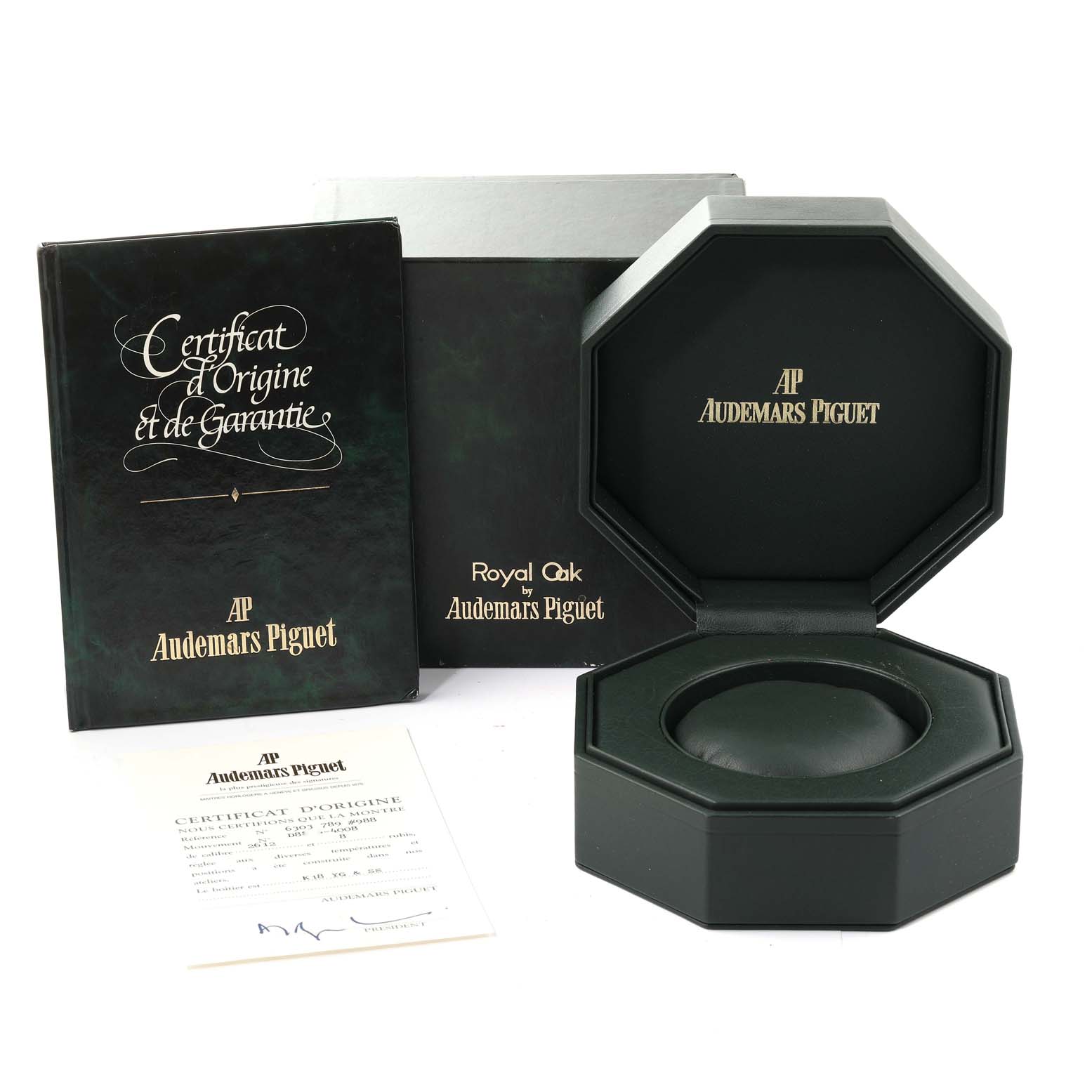 This image shows the packaging, certificate, and presentation box for a Royal Oak model by Audemars Piguet, including various documentation.