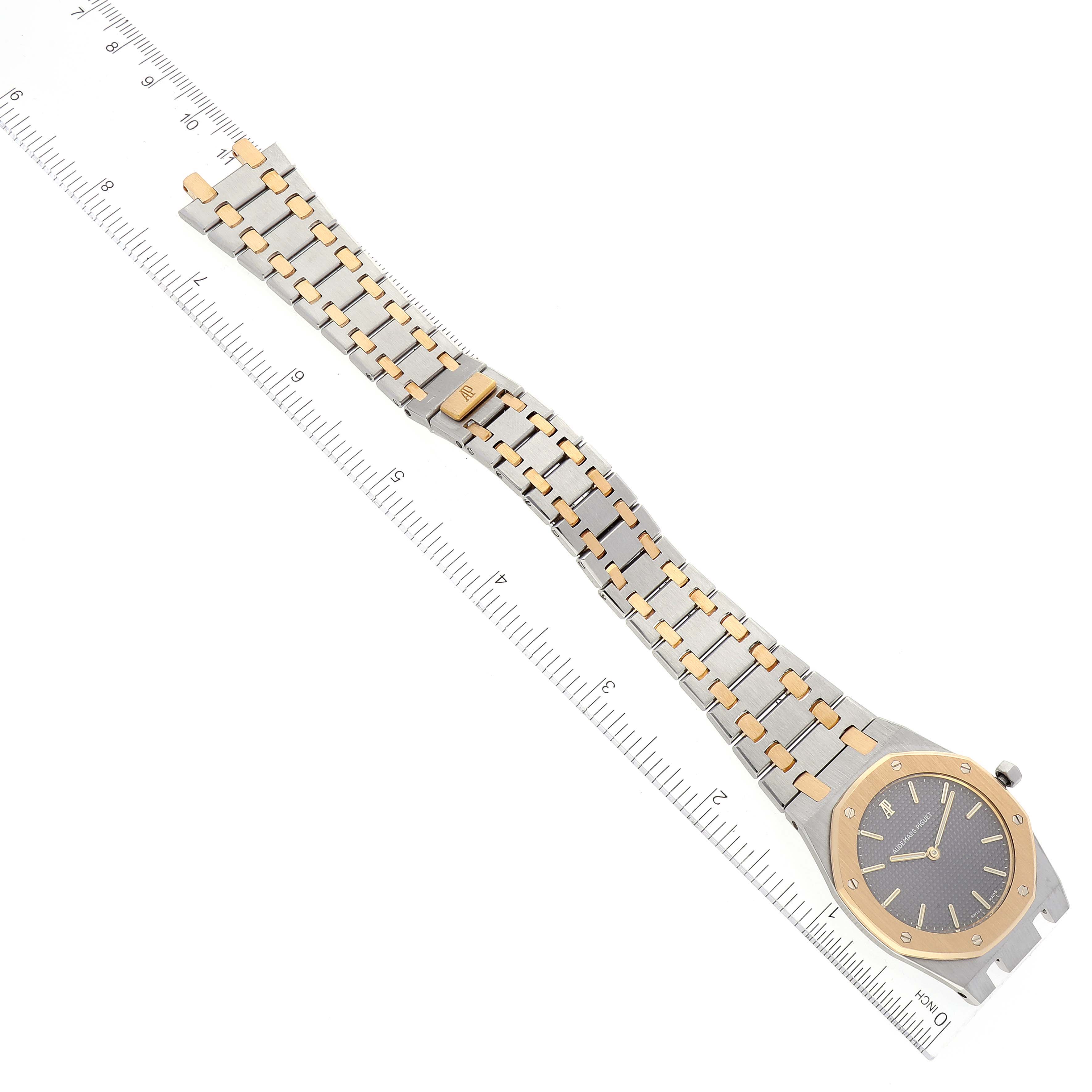 The image shows an overhead view of a Royal Oak watch by Audemars Piguet, displaying its bracelet and face.