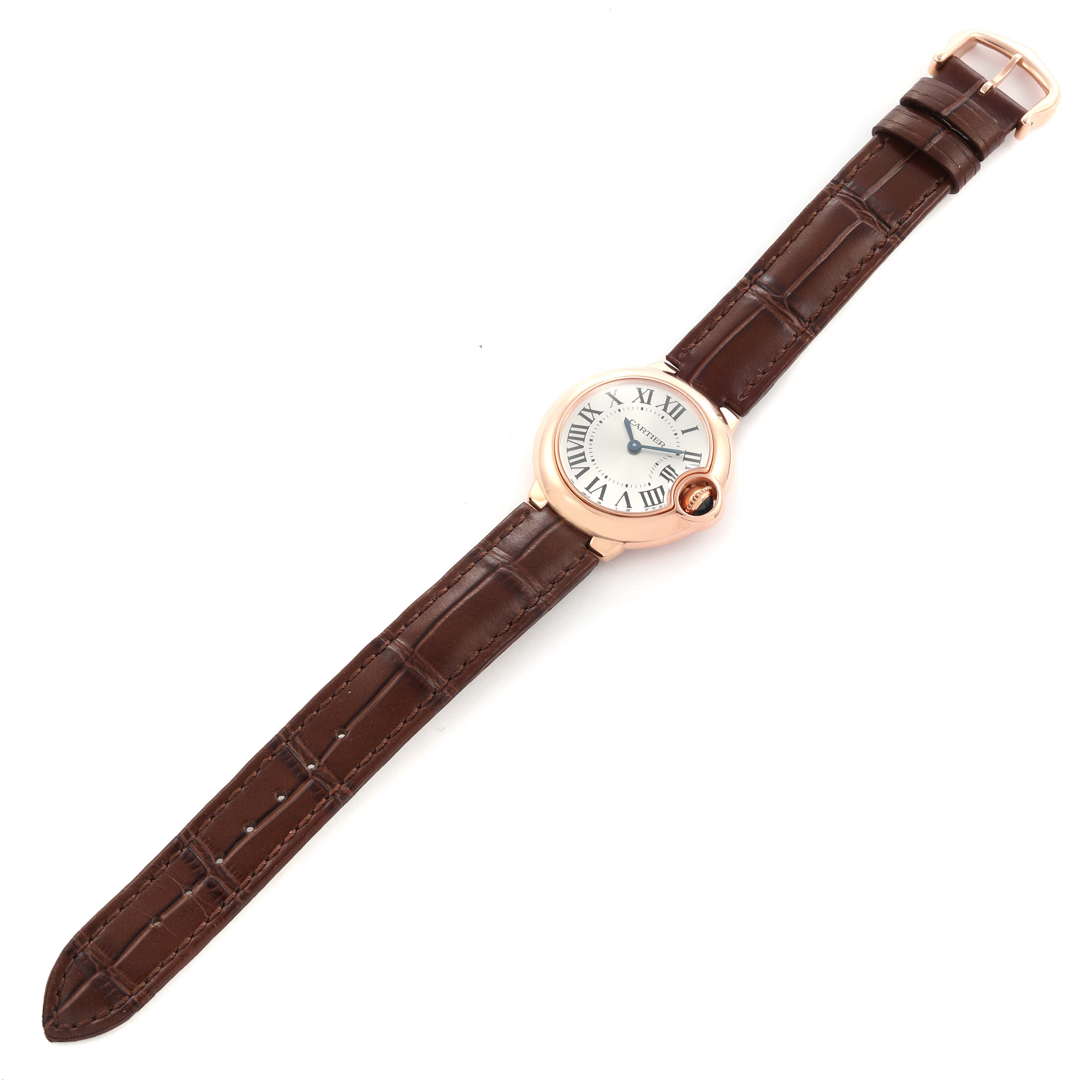 The Cartier Ballon Bleu W6900256 Women
s Rose Gold Silver Dial W6900256 Women
s Rose Gold Silver Dial watch is shown flat from above, displaying the face, case, and brown leather strap.