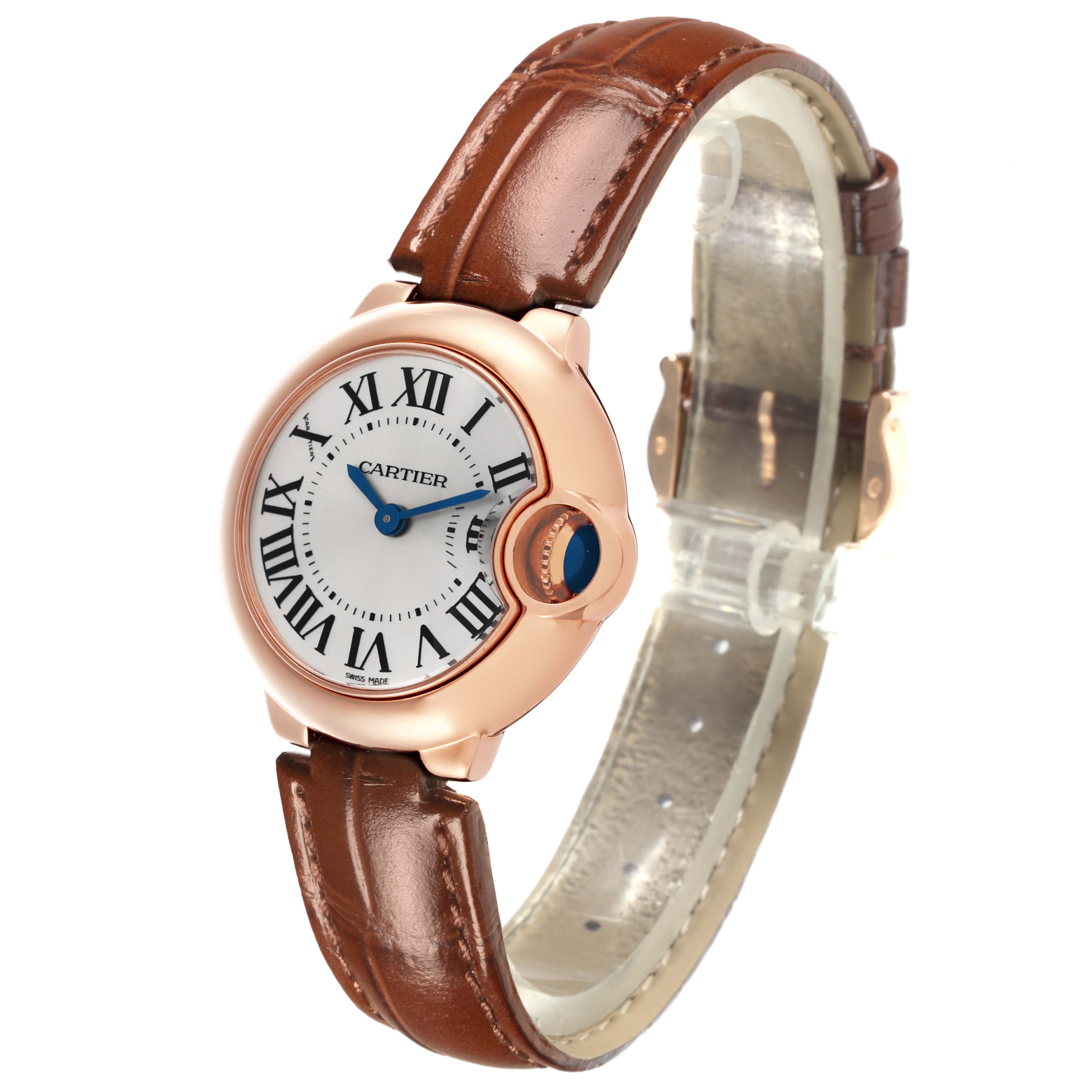 The Cartier Ballon Bleu W6900256 Women
s Rose Gold Silver Dial W6900256 Women
s Rose Gold Silver Dial watch is shown at an angle highlighting the face, Roman numerals, and brown leather strap.
