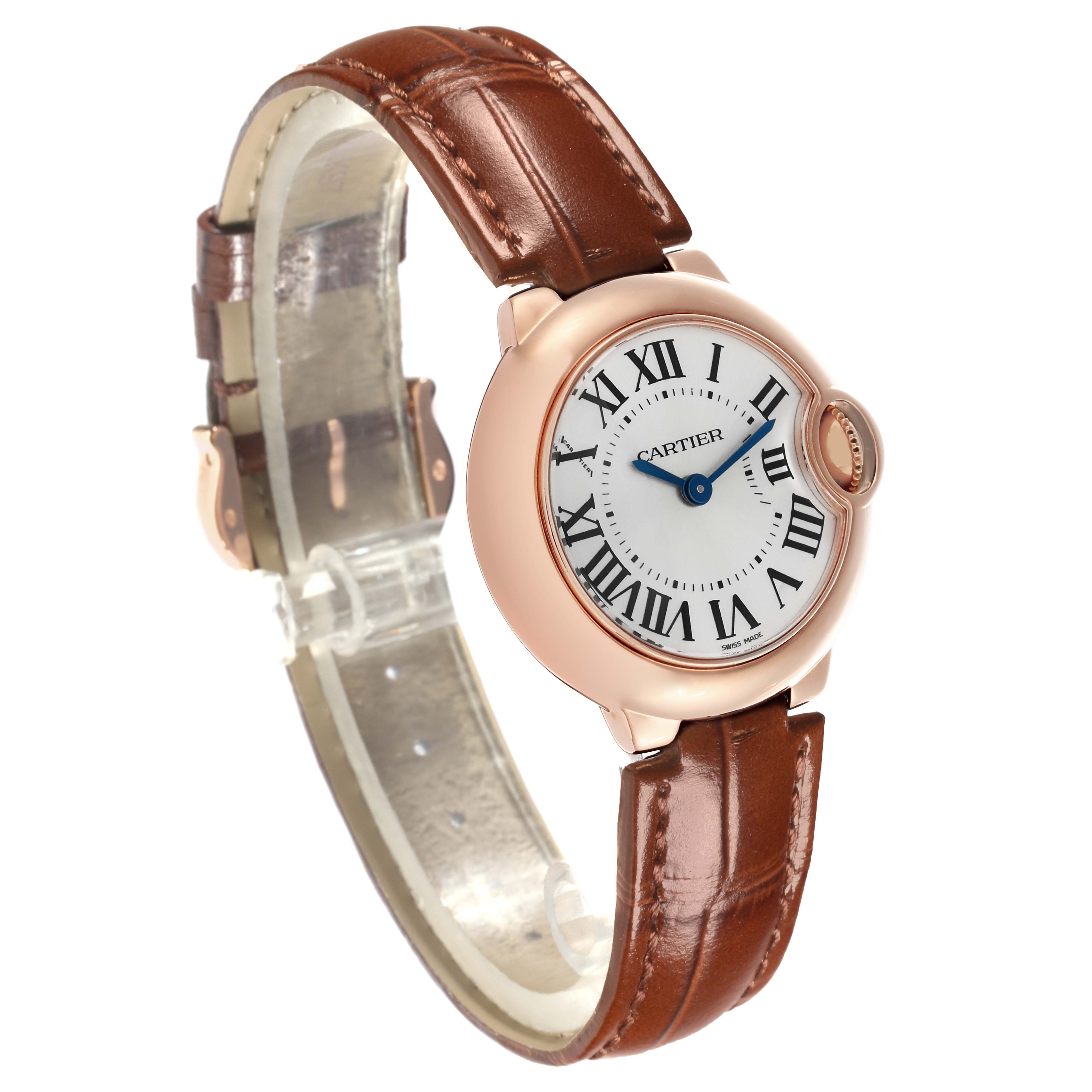 The Cartier Ballon Bleu W6900256 Women
s Rose Gold Silver Dial W6900256 Women
s Rose Gold Silver Dial watch is shown at a three-quarter angle, displaying its dial, case, and brown leather strap.