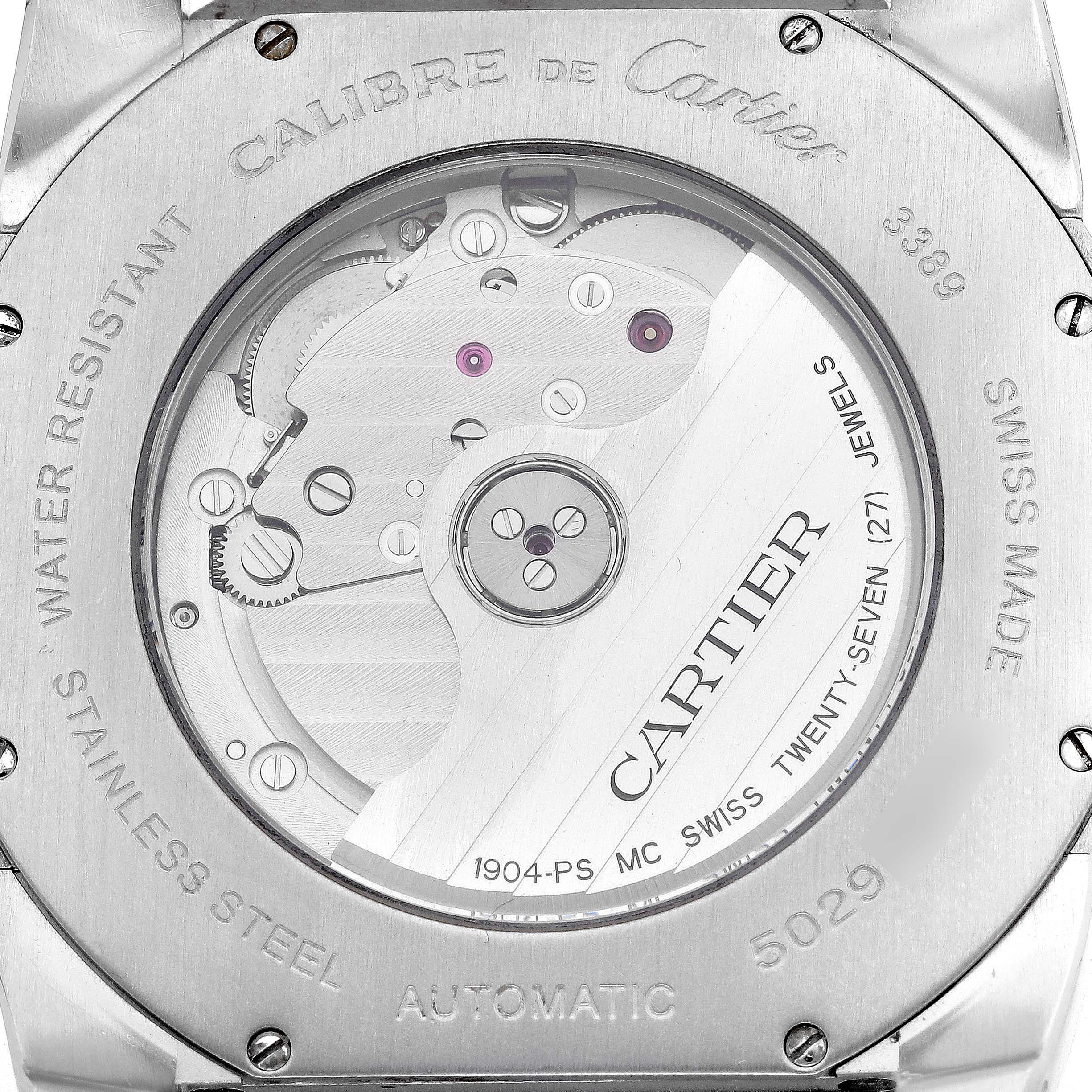 The image shows the back of a Calibre de Cartier watch, highlighting its automatic movement and internal mechanics.