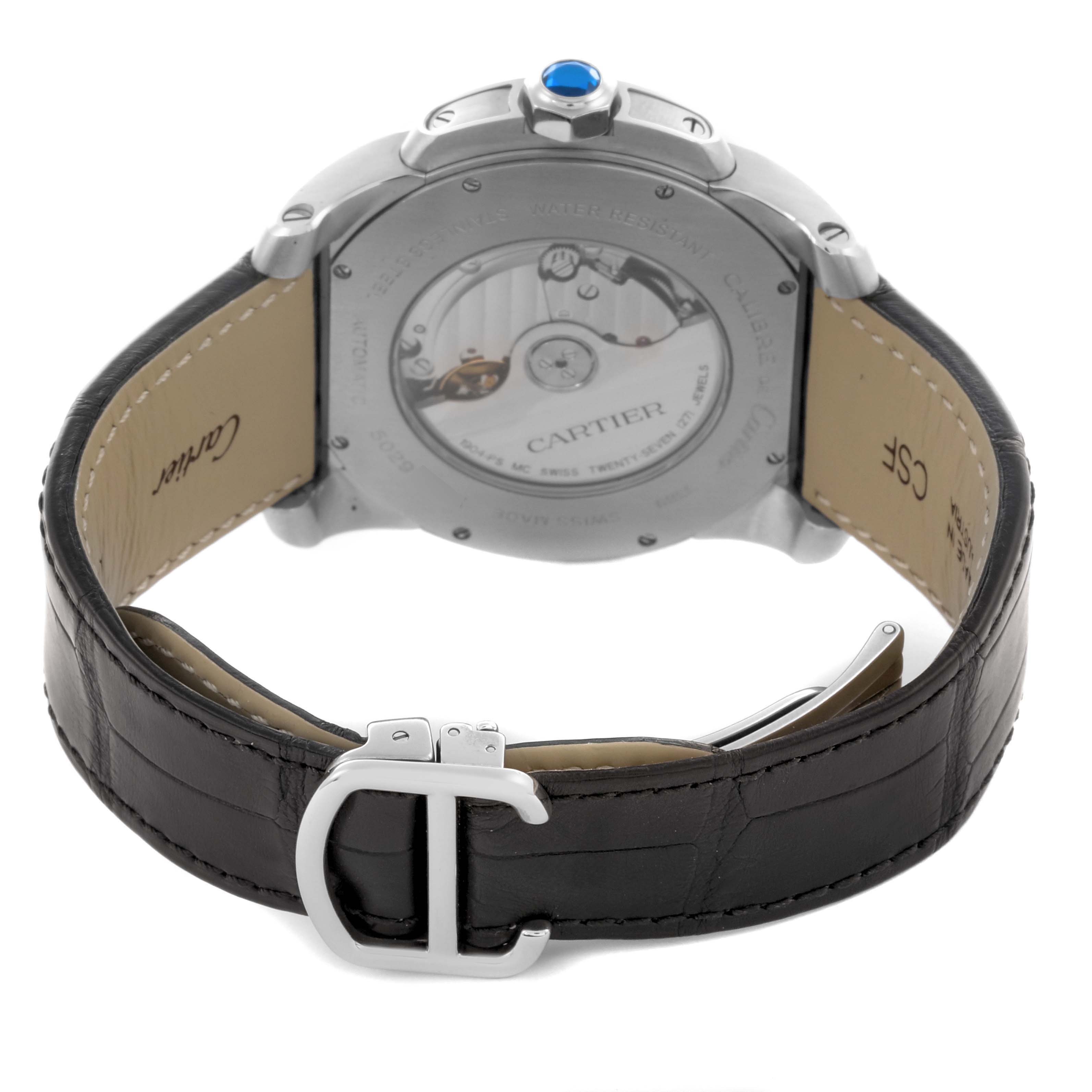 The Calibre de Cartier watch is shown from the back, highlighting the case back, strap, and buckle.