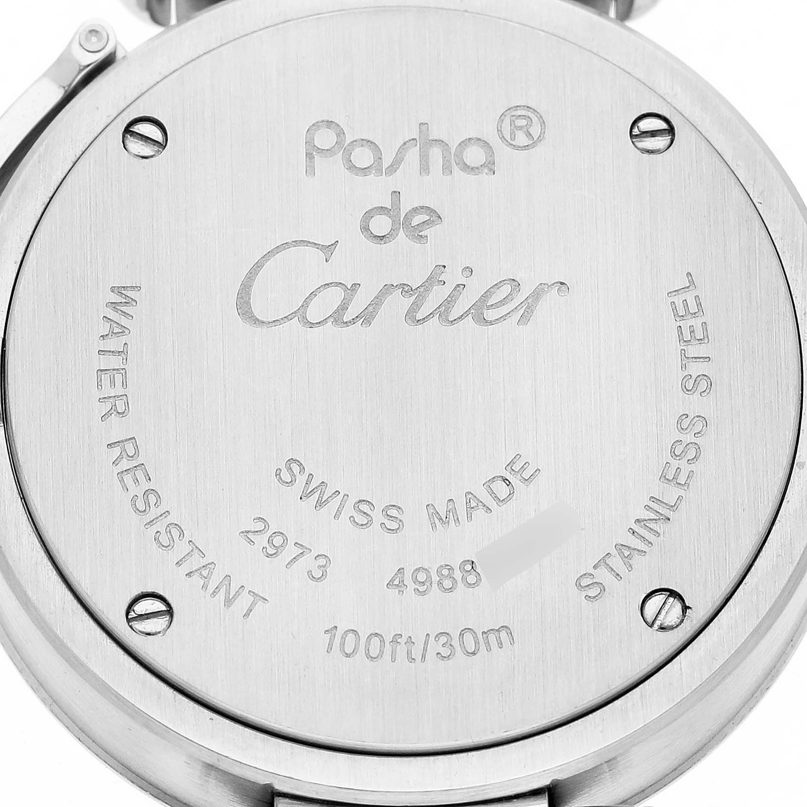 The image shows the back case of a Pasha model by Cartier, highlighting engravings and screw details.