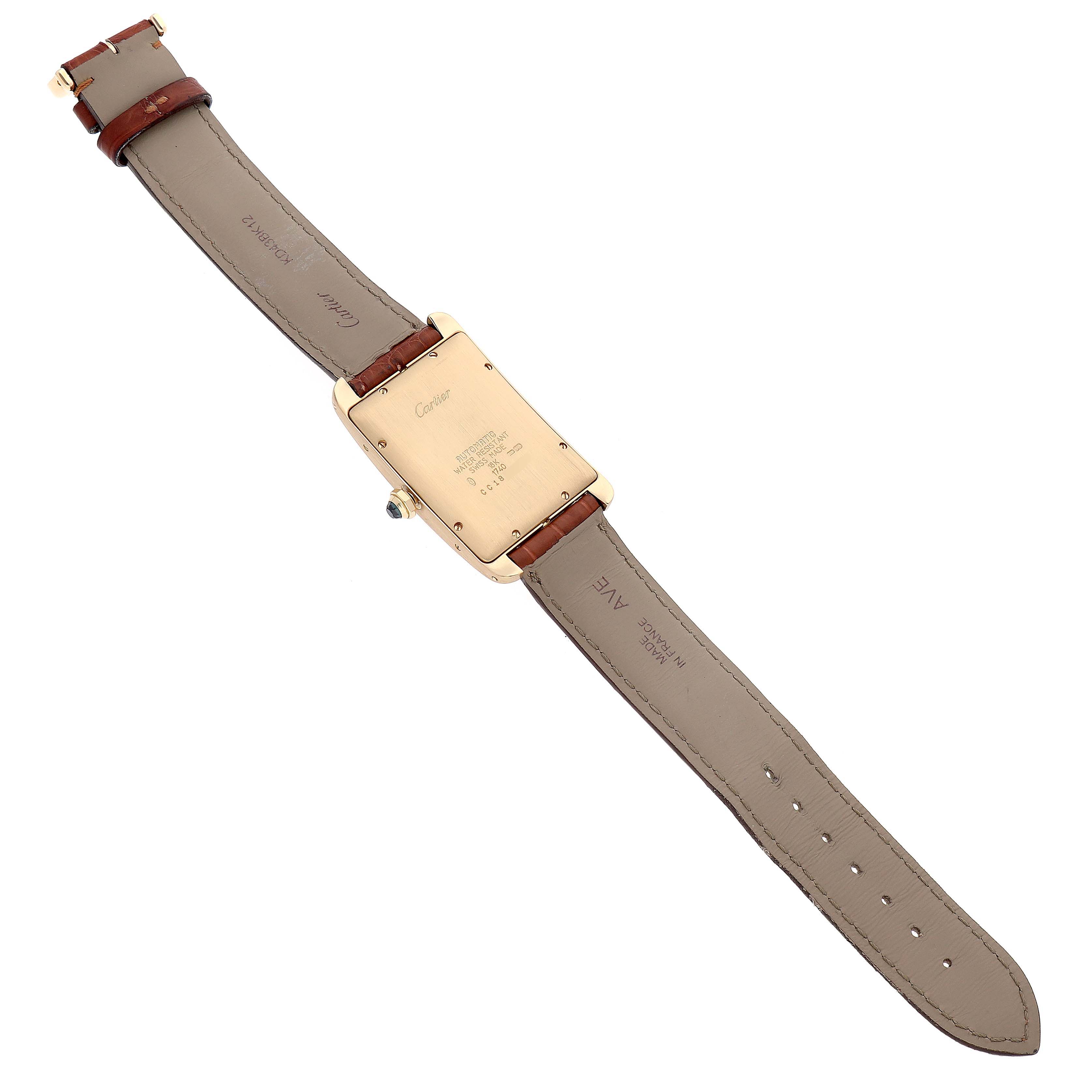 The image shows the back side and strap of the Cartier Tank Americaine W2603156 Men's Yellow Gold Silver Dial W2603156 Men's Yellow Gold Silver Dial model watch, featuring its case back, strap, and buckle.