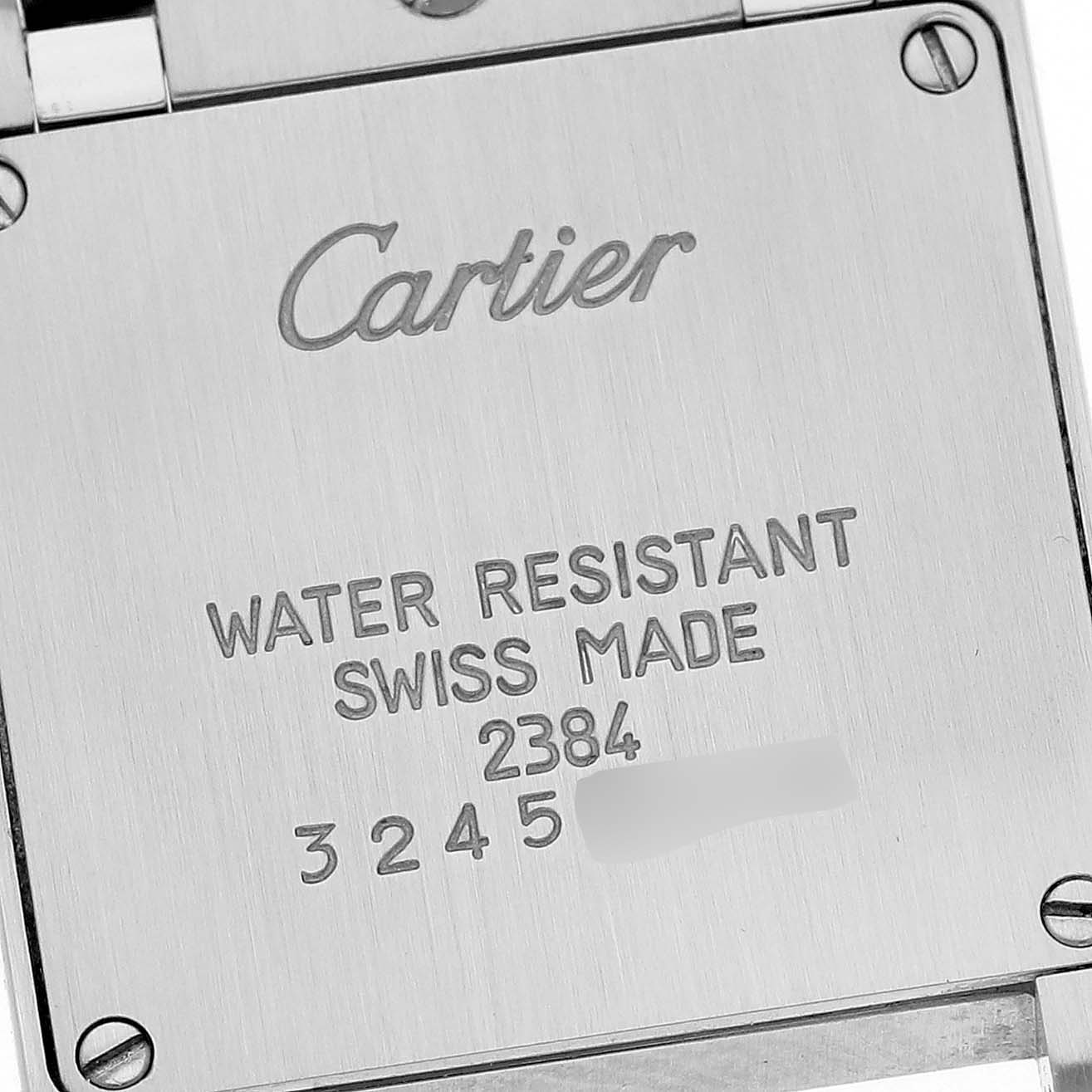 This image shows the backside of the Cartier Tank Française watch with engraved details about its water resistance and Swiss origin.