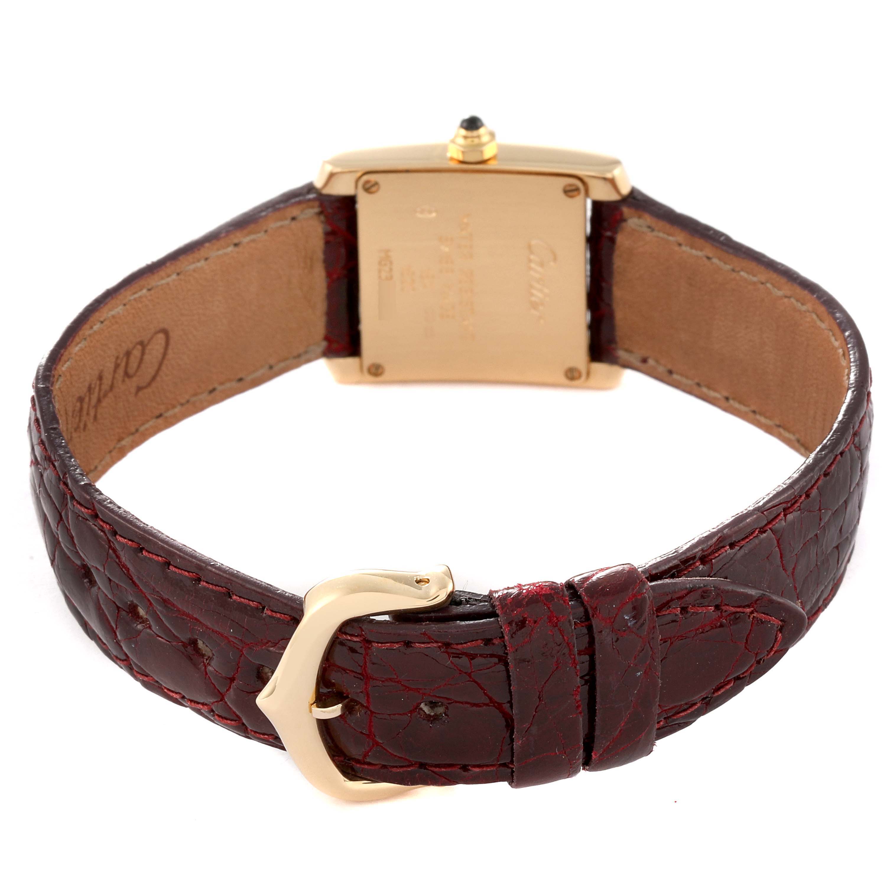 This image shows the back view of a Cartier Tank Française watch, highlighting its leather strap and gold buckle.