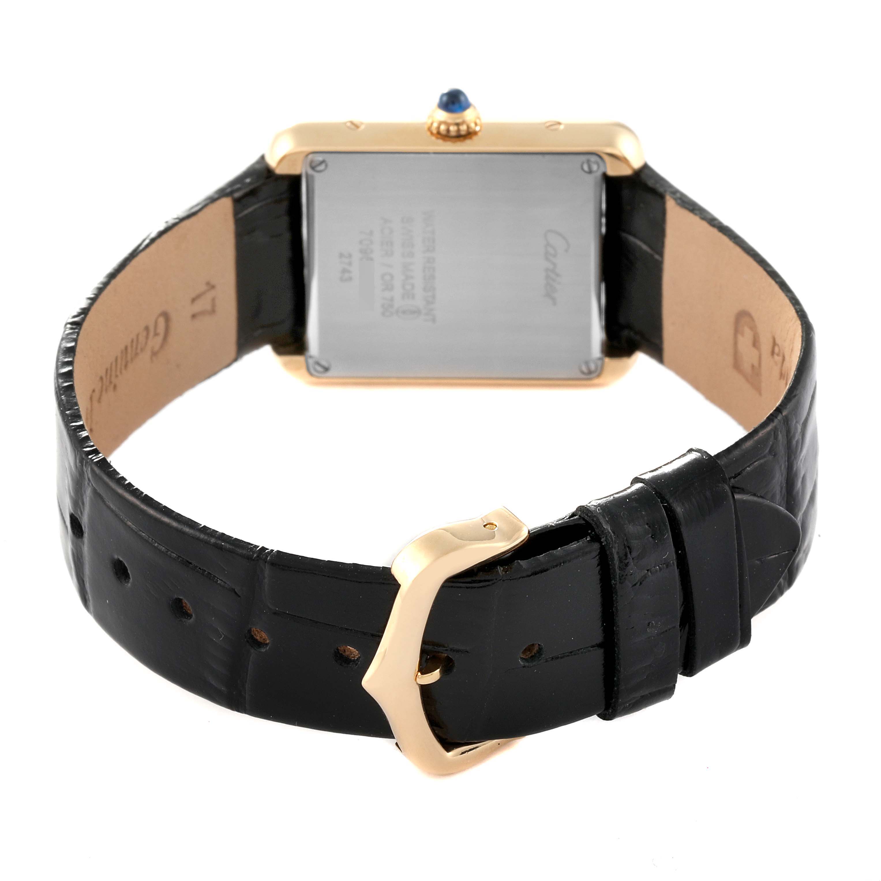 The image shows the back view of a Cartier Tank Solo W1018755 Women
s Steel and Gold (two tone) Silver Dial W1018755 Women
s Steel and Gold (two tone) Silver Dial watch, highlighting the case back and black leather strap with a gold buckle.