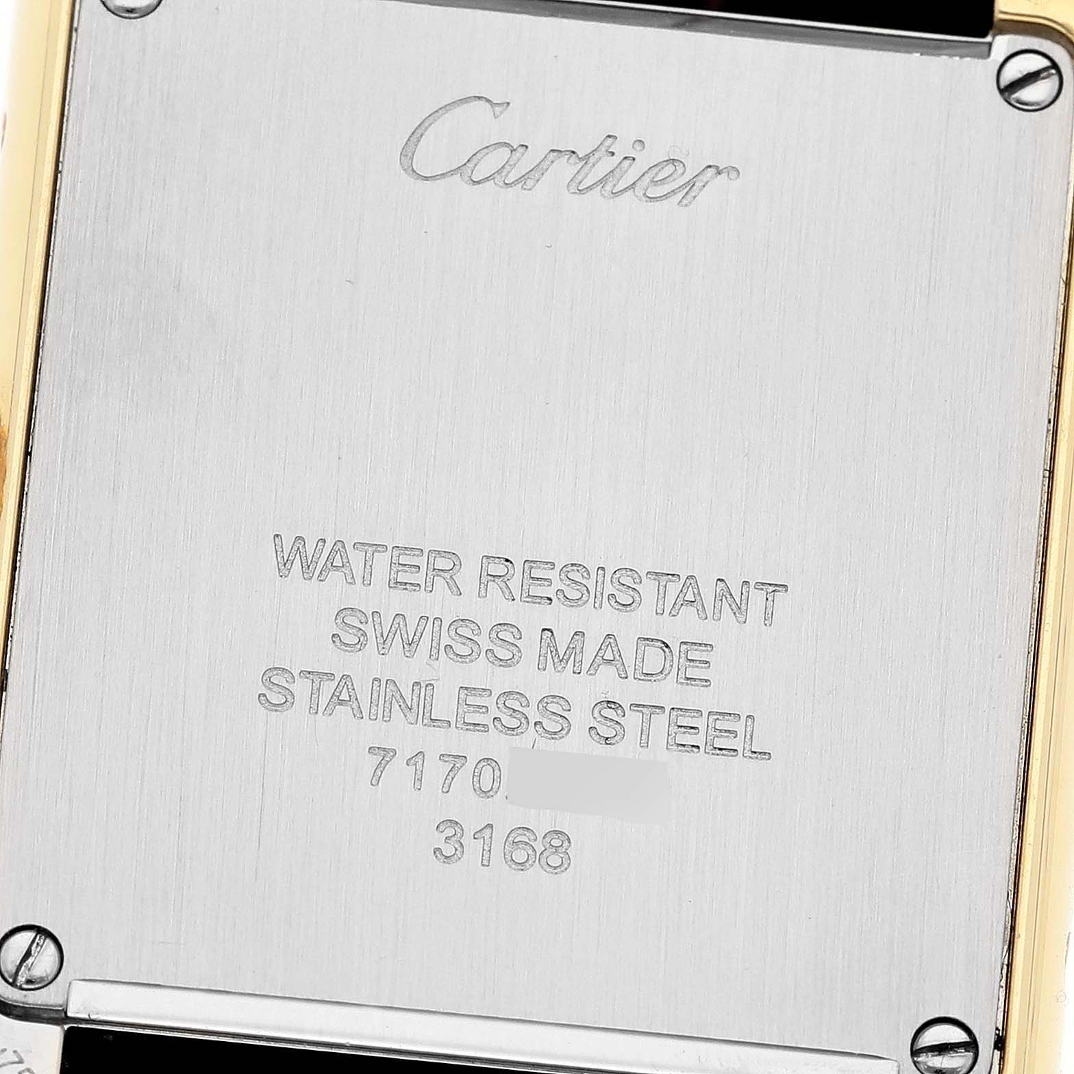 This image shows the back case of a Cartier Tank Solo W5200002 Women
s Steel and Gold (two tone) Silver Dial W5200002 Women
s Steel and Gold (two tone) Silver Dial watch, highlighting its inscriptions and screw details.