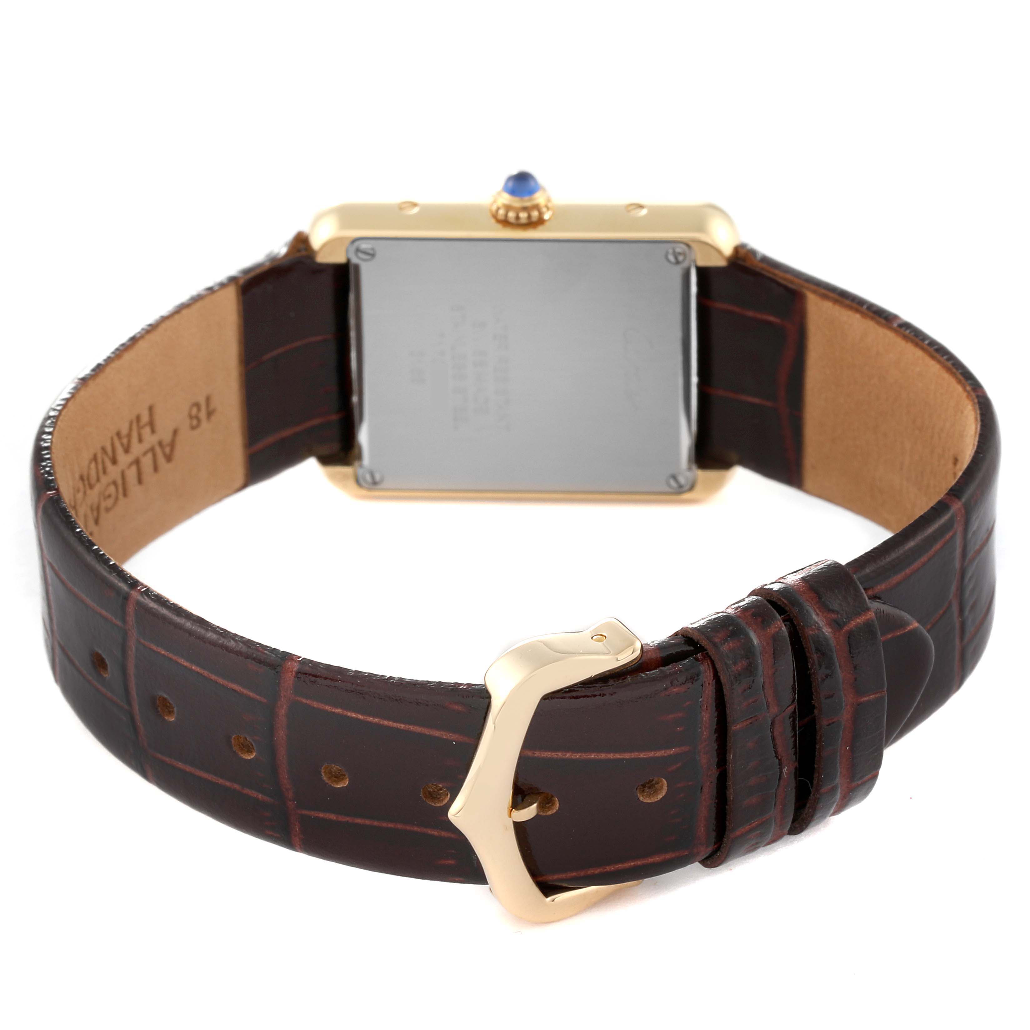 The image shows the back view of a Cartier Tank Solo W5200002 Women
s Steel and Gold (two tone) Silver Dial W5200002 Women
s Steel and Gold (two tone) Silver Dial watch, highlighting its case back, crown, leather strap, and buckle.