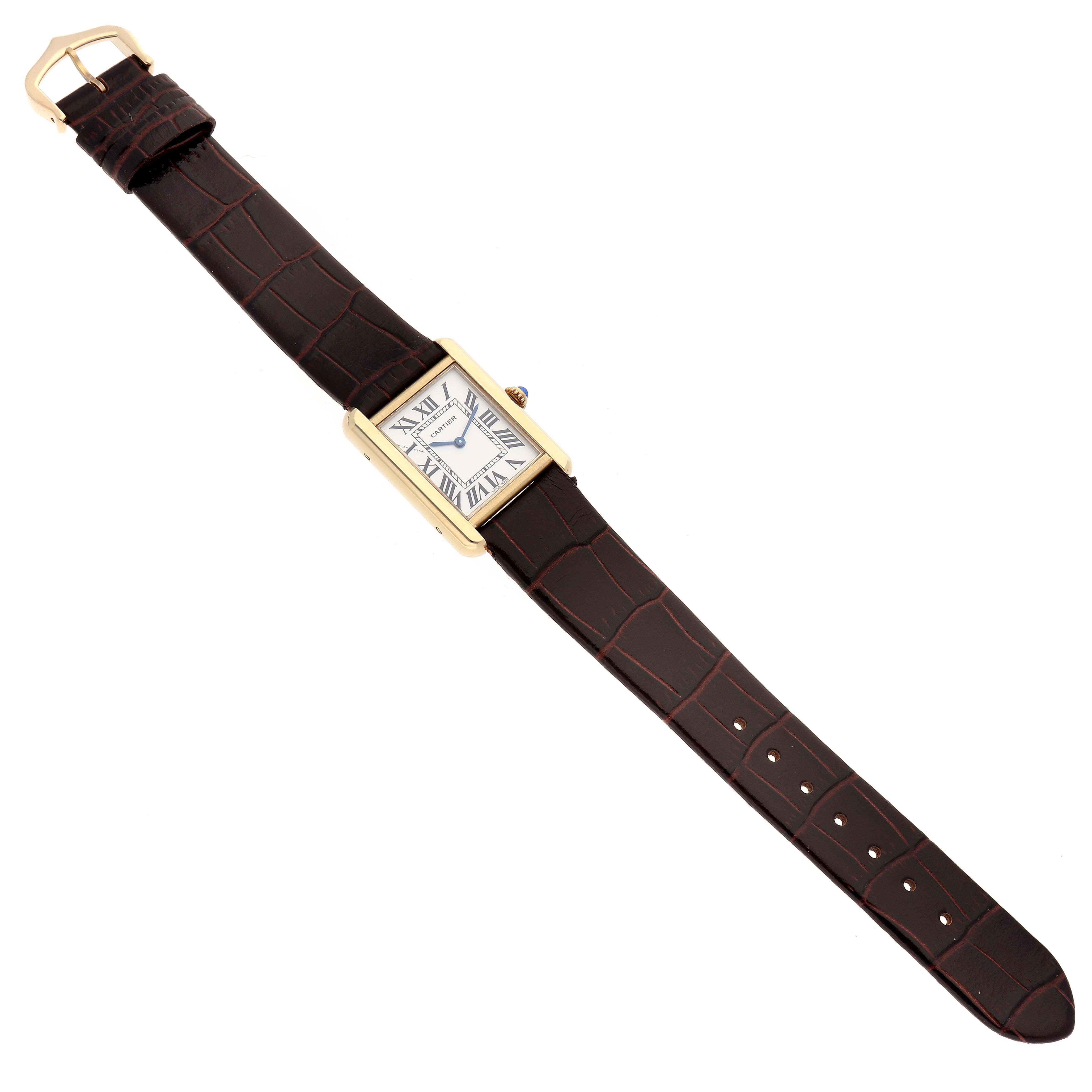 The Cartier Tank Solo W5200002 Women
s Steel and Gold (two tone) Silver Dial W5200002 Women
s Steel and Gold (two tone) Silver Dial watch is shown from a top-down angle, displaying the entire brown leather strap and rectangular face.