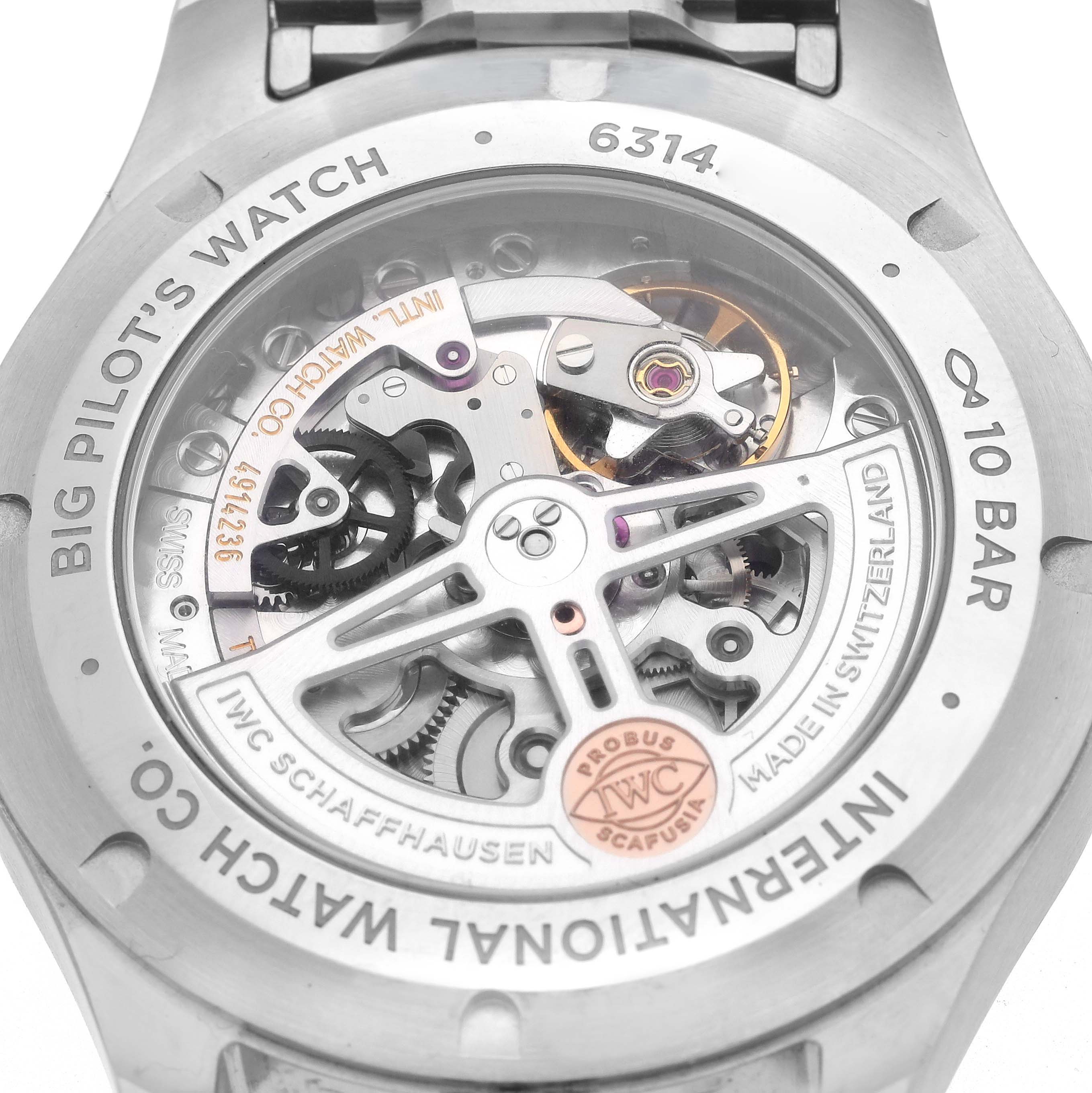 The image shows the back case of the IWC Big Pilot's Watch, featuring the movement and engravings.