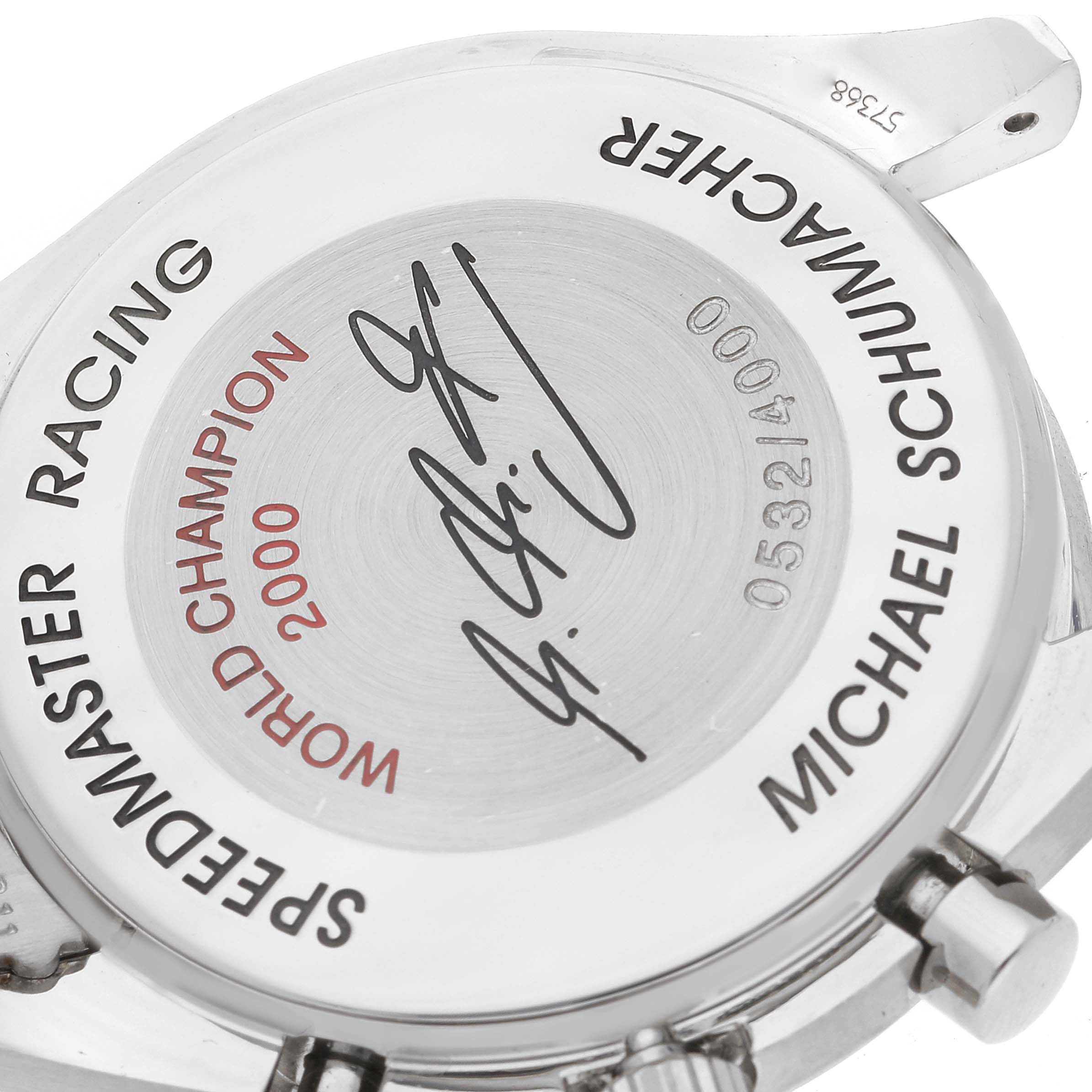 The image shows the back case of an Omega Speedmaster 3517.30.00 Men's Stainless Steel Silver Dial 3517.30.00 Men's Stainless Steel Silver Dial Racing watch, featuring inscriptions and an engraved signature.