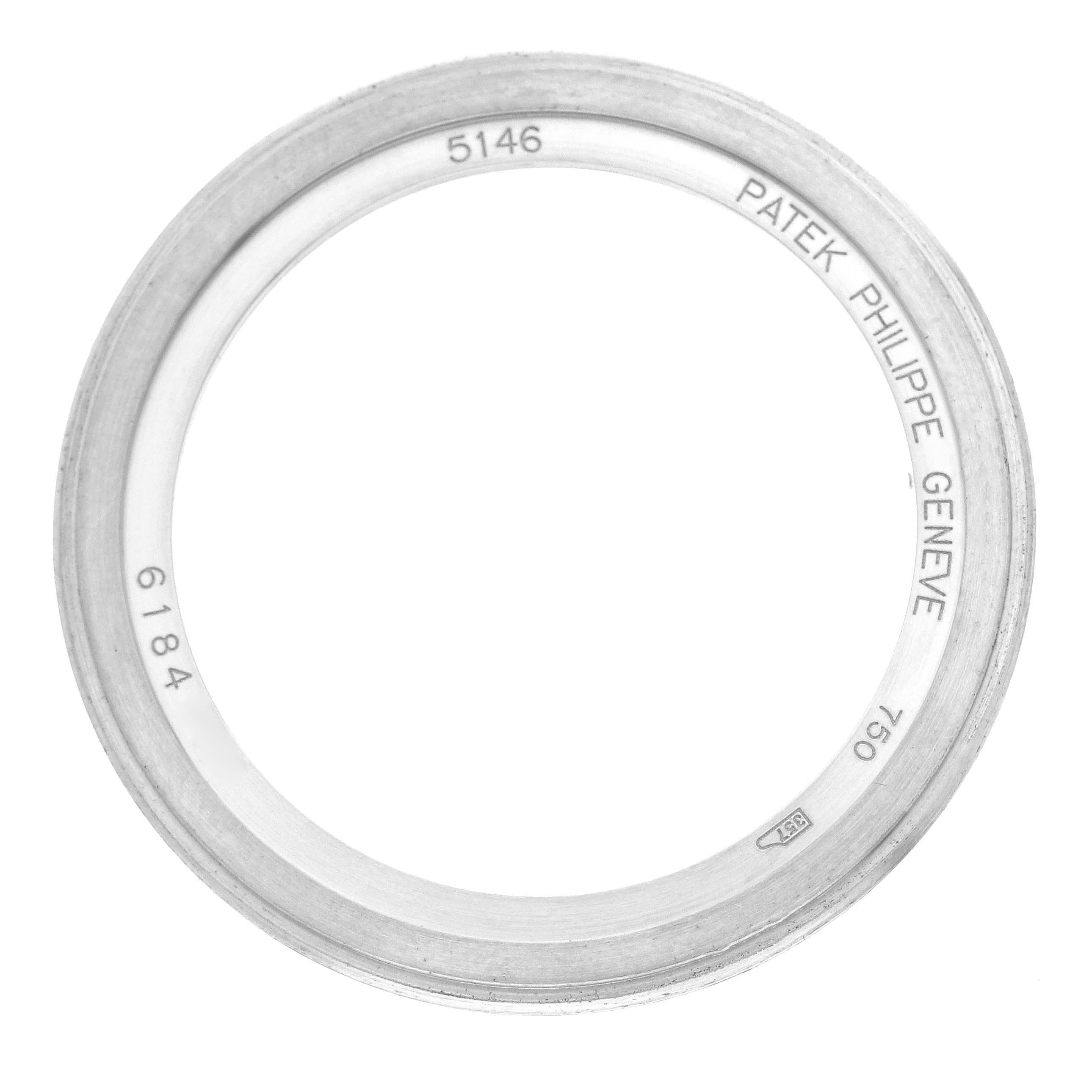 The image shows a bezel from the Patek Philippe Complications 5146G Men's White Gold Grey Dial 5146G Men's White Gold Grey Dial model, viewed from above, featuring engraved details and model number.