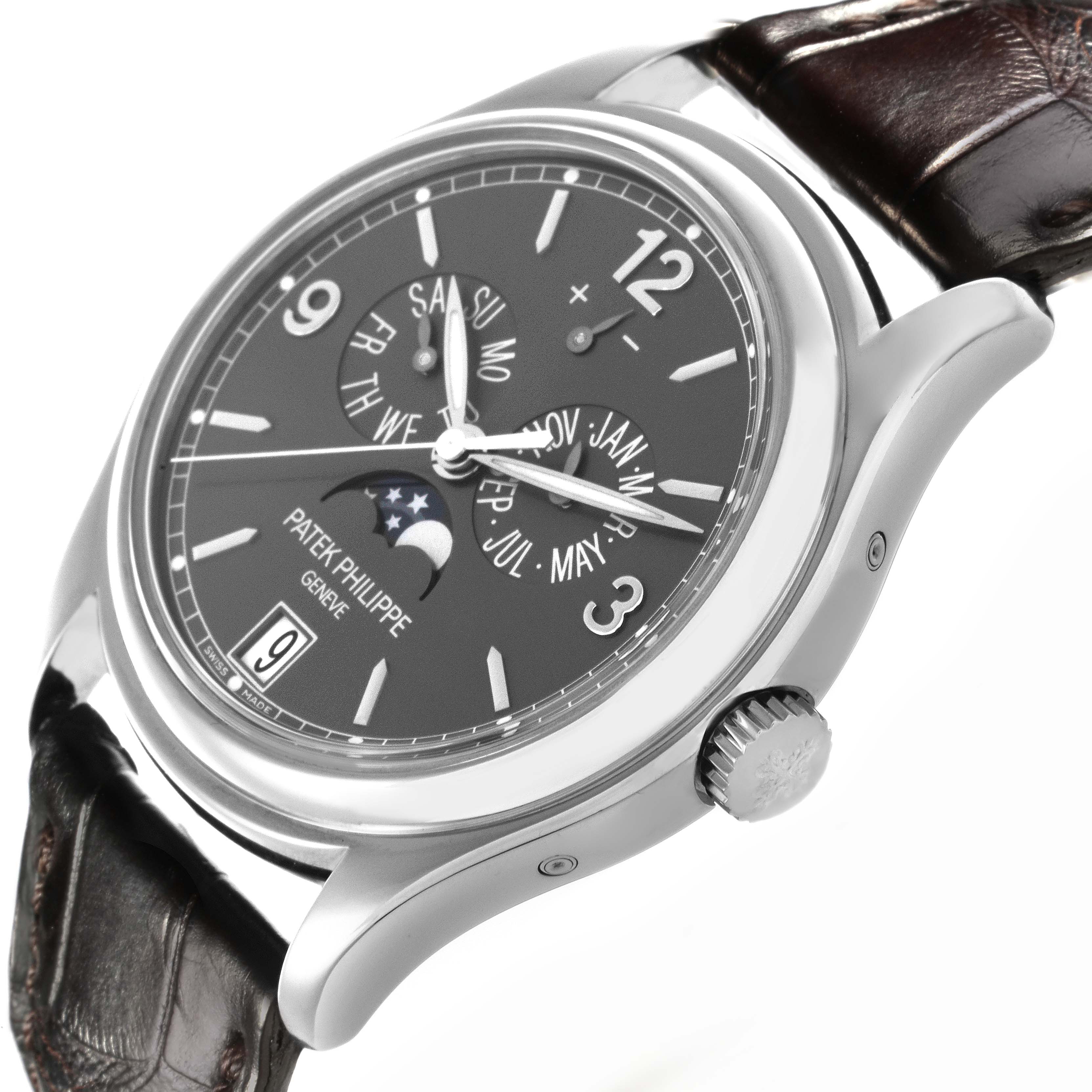 The Patek Philippe Complications 5146G Men's White Gold Grey Dial 5146G Men's White Gold Grey Dial watch is shown from a side angle, featuring the crown, watch face, and leather strap.