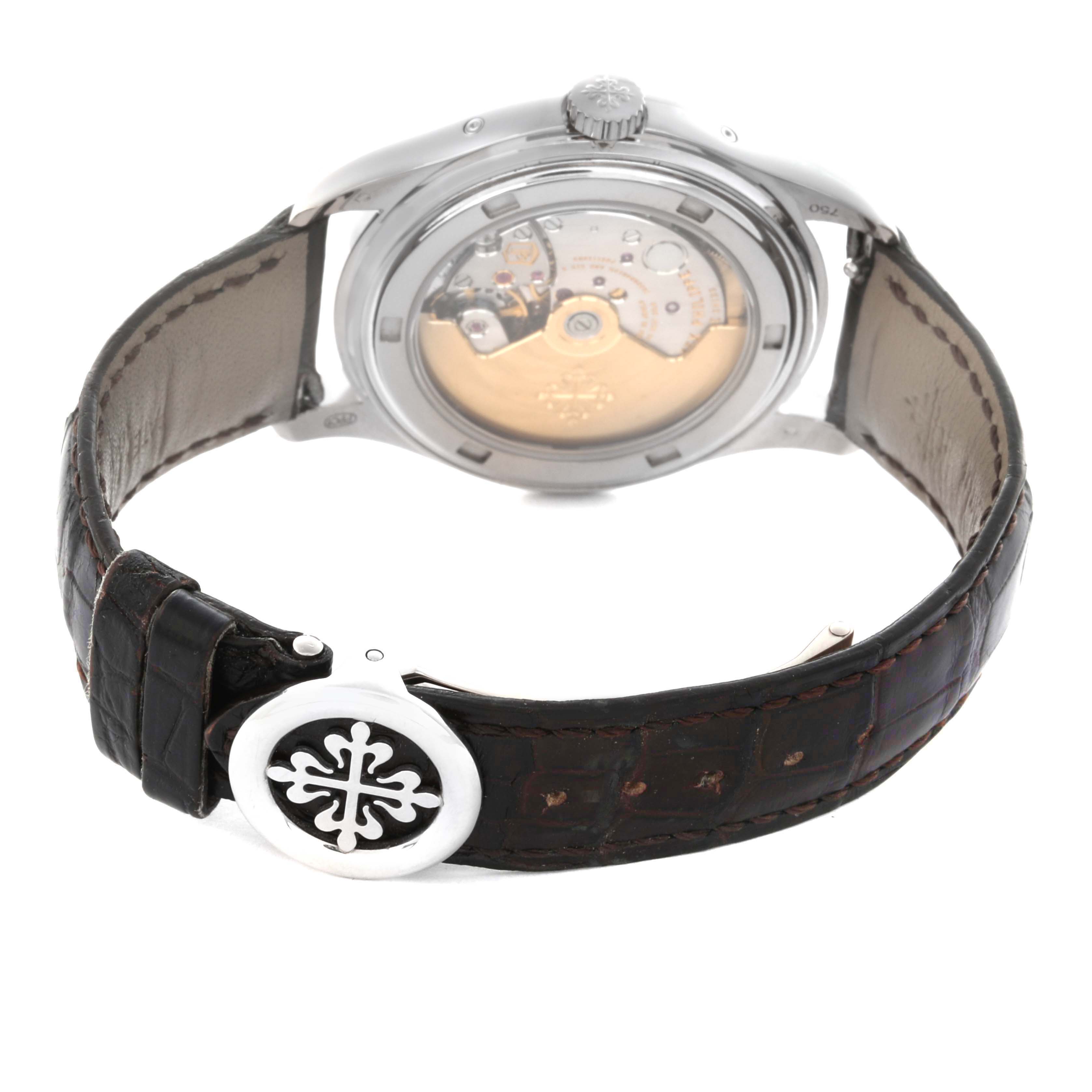 The Patek Philippe Complications 5146G Men's White Gold Grey Dial 5146G Men's White Gold Grey Dial watch is shown from the back, highlighting the movement and leather strap with a clasp.