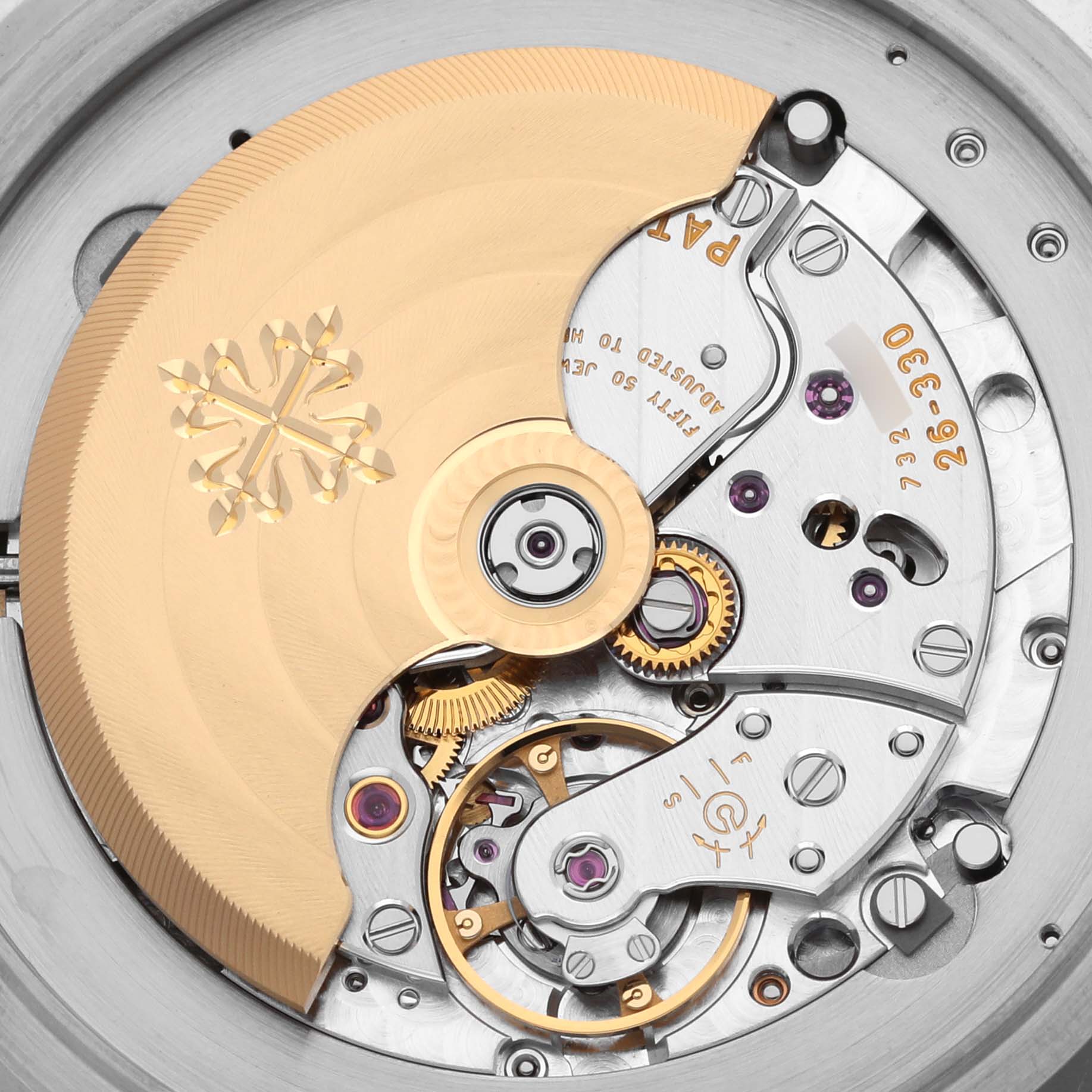 The image shows a close-up of the movement mechanism of the Patek Philippe Complications 5212A-001 Men's Stainless Steel Silver Dial 5212A-001 Men's Stainless Steel Silver Dial watch, focusing on gears and the rotor.