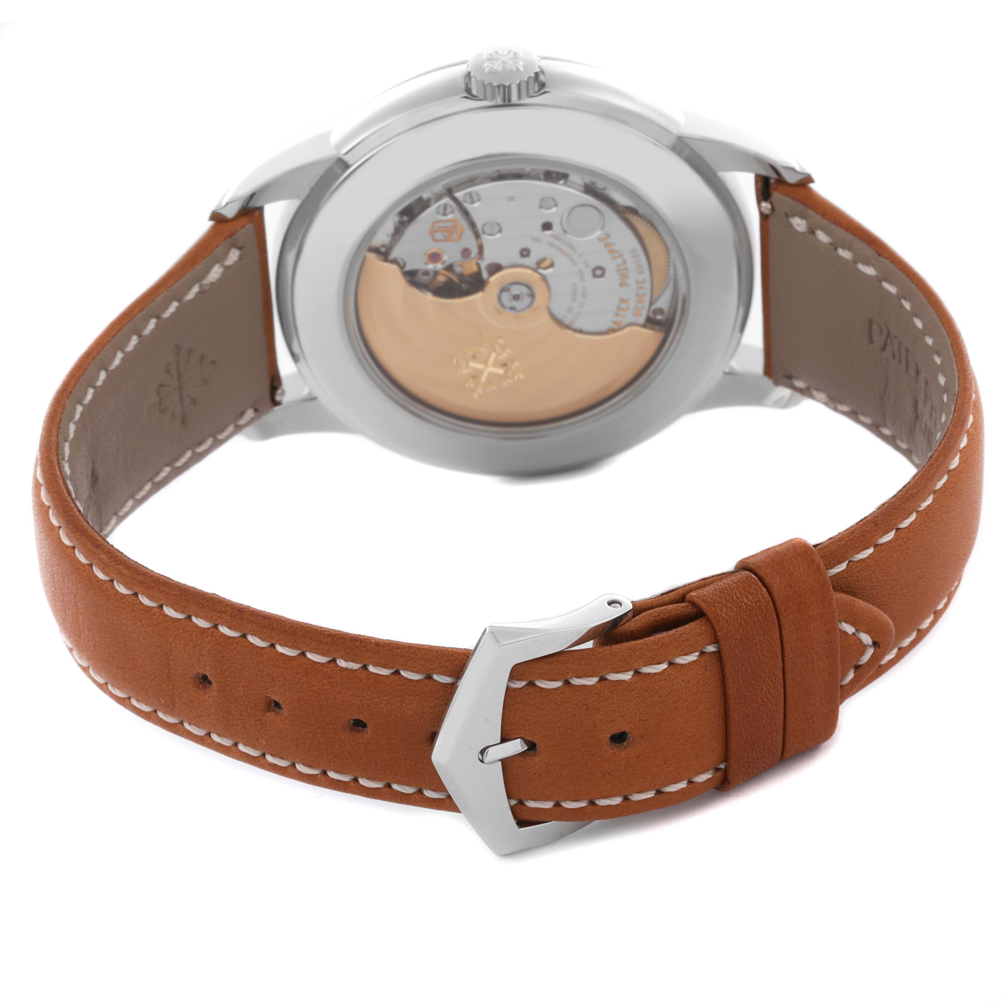 The image shows the back view of a Patek Philippe Complications 5212A-001 Men's Stainless Steel Silver Dial 5212A-001 Men's Stainless Steel Silver Dial model, highlighting the movement and leather strap with buckle.