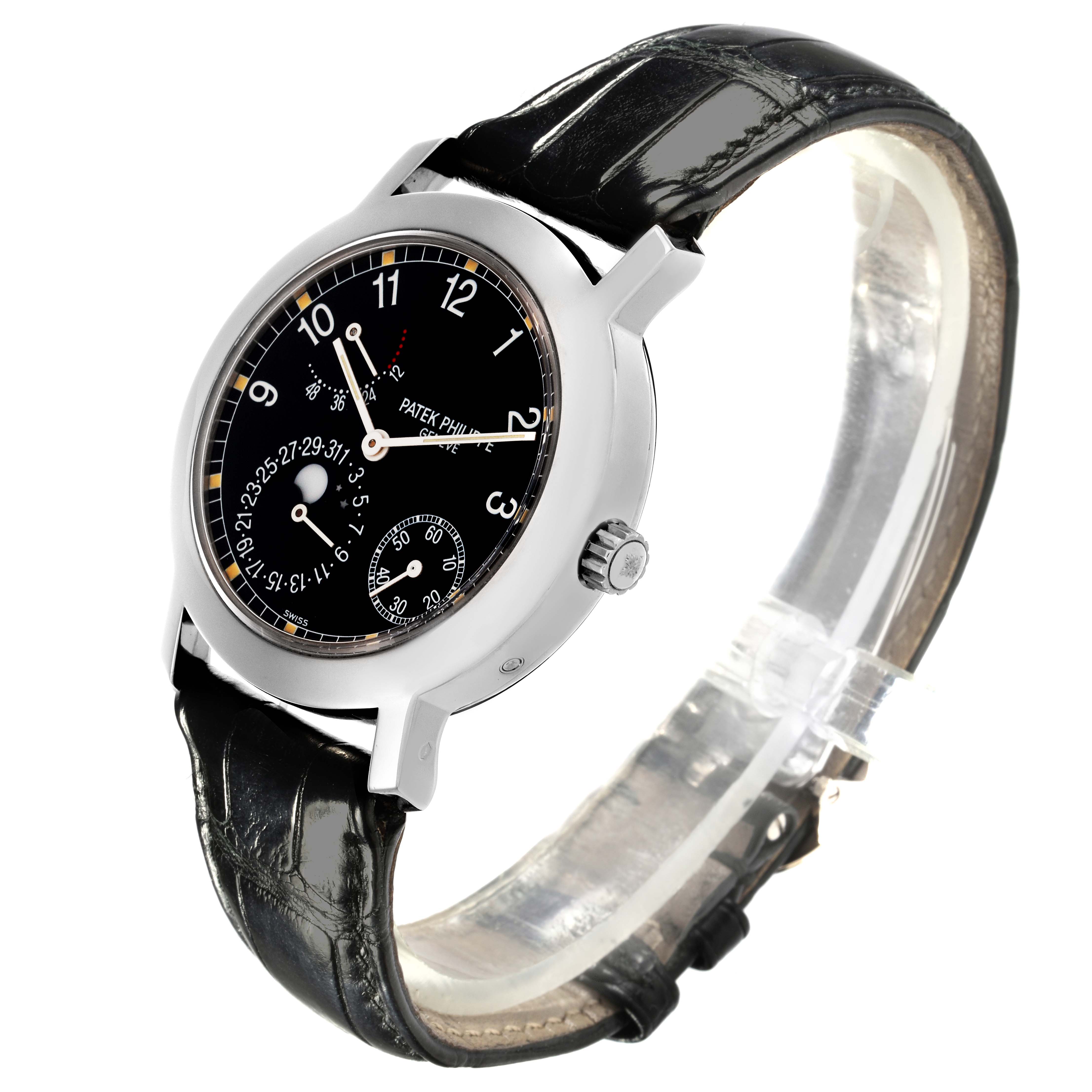 The Patek Philippe Complications 5055G-001 Men's White Gold Black Dial 5055G-001 Men's White Gold Black Dial watch is shown at a tilted angle, highlighting the dial and black leather strap.