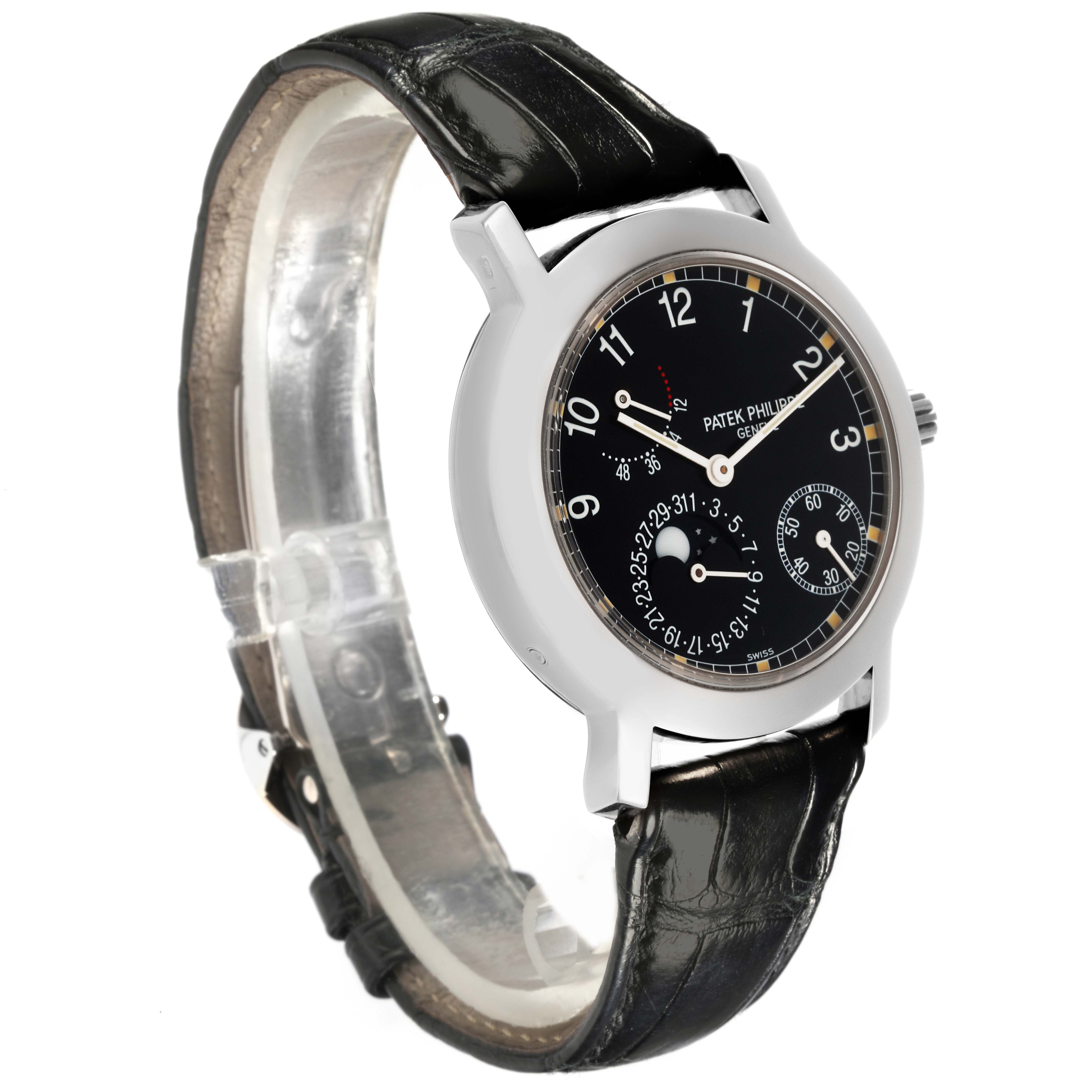 The Patek Philippe Complications 5055G-001 Men's White Gold Black Dial 5055G-001 Men's White Gold Black Dial watch is shown at an angled side view, displaying the black dial, case, and leather strap.