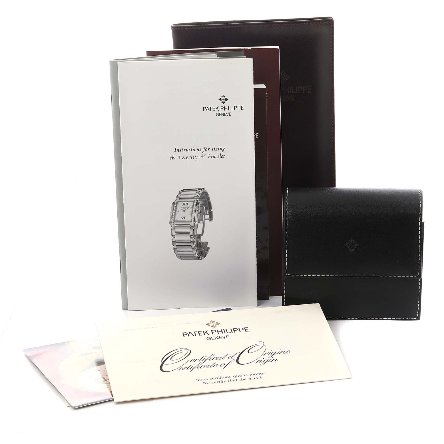 The image shows Patek Philippe's Twenty-4 model accessories, including manuals, a certificate, and a leather pouch.