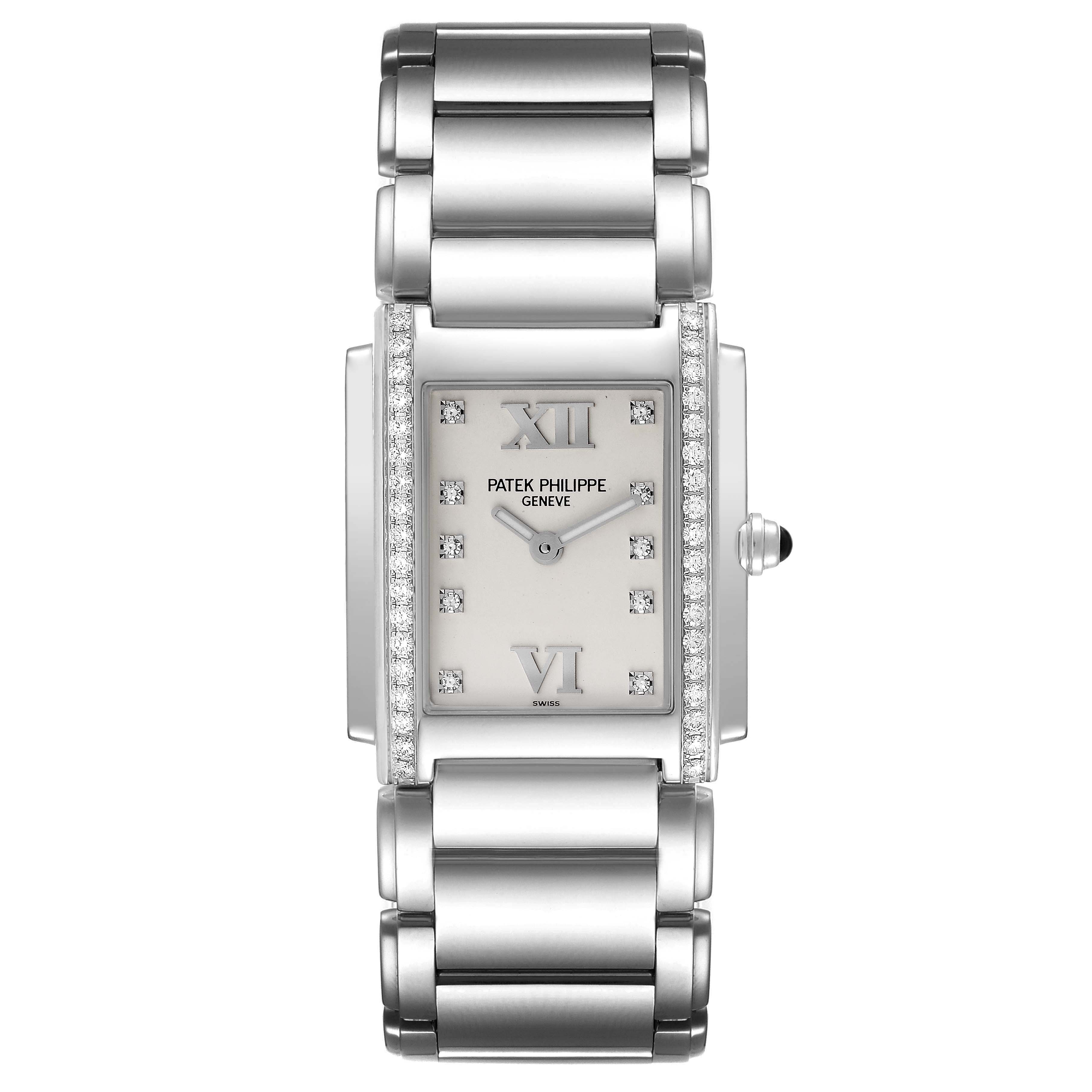 The image shows a front view of the Patek Philippe Twenty-4 4910/10A-011 Women's Stainless Steel Silver Dial 4910/10A-011 Women's Stainless Steel Silver Dial watch, displaying its rectangular face and metal bracelet.