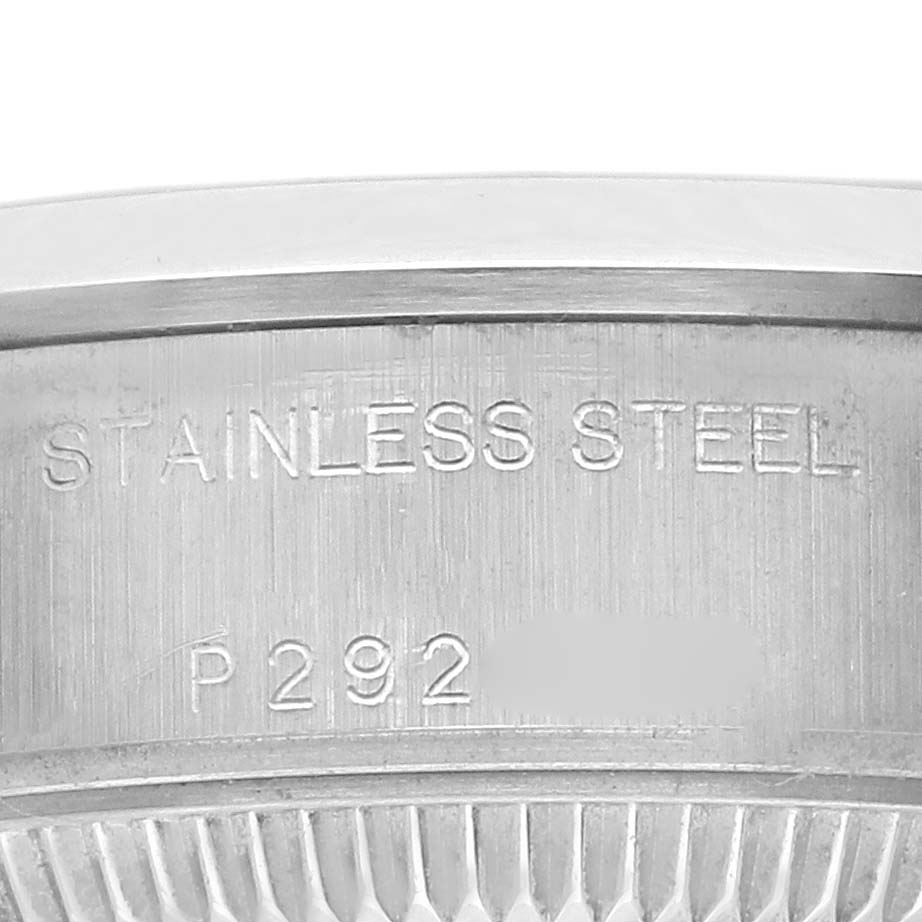 The image shows a close-up of the engravings on the bezel of a Rolex Date 79160 Women's Stainless Steel Pink Dial 79160 Women's Stainless Steel Pink Dial model, highlighting "STAINLESS STEEL."