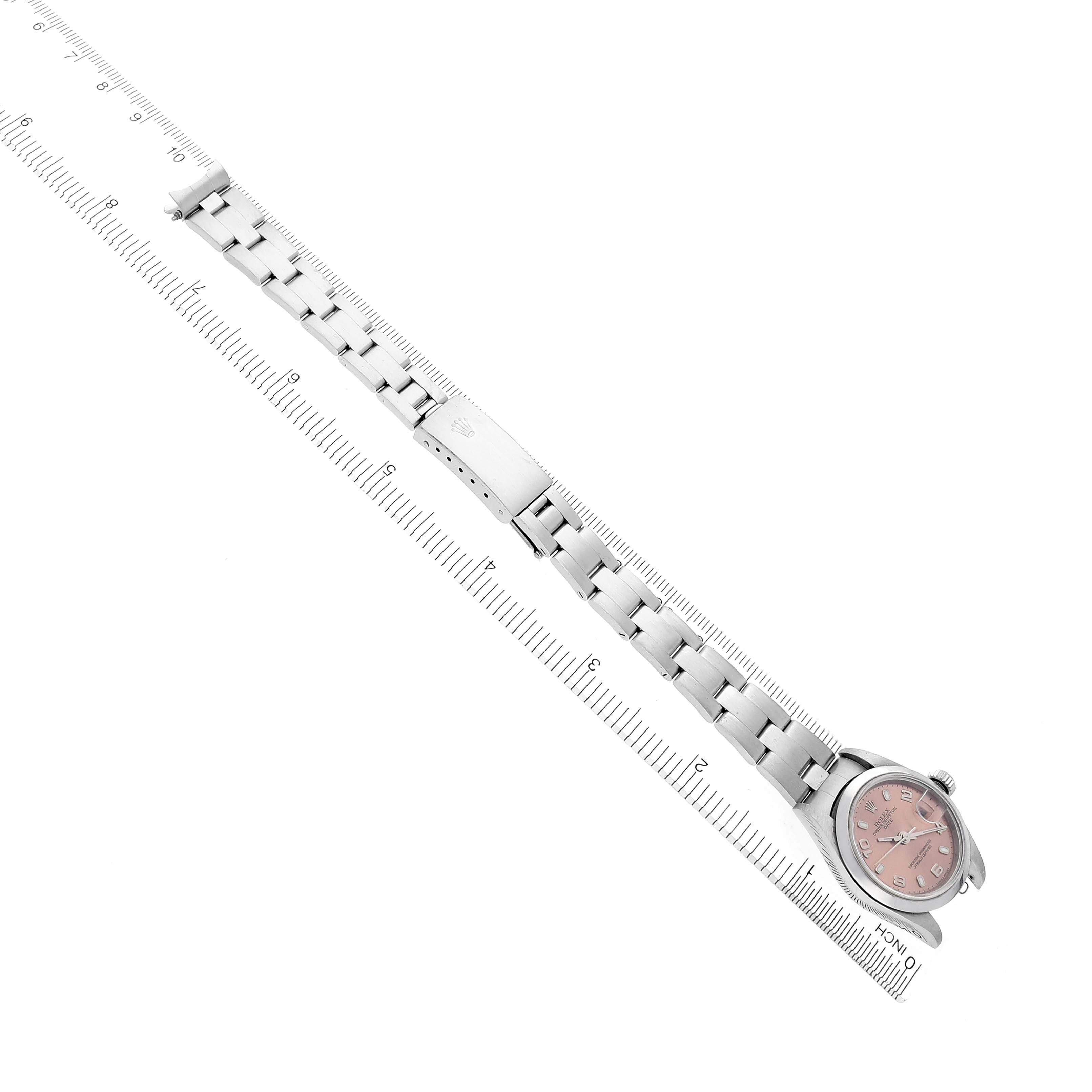 The image shows a Rolex Date 79160 Women's Stainless Steel Pink Dial 79160 Women's Stainless Steel Pink Dial watch, angled diagonally, displaying the dial and full metal bracelet alongside a ruler.