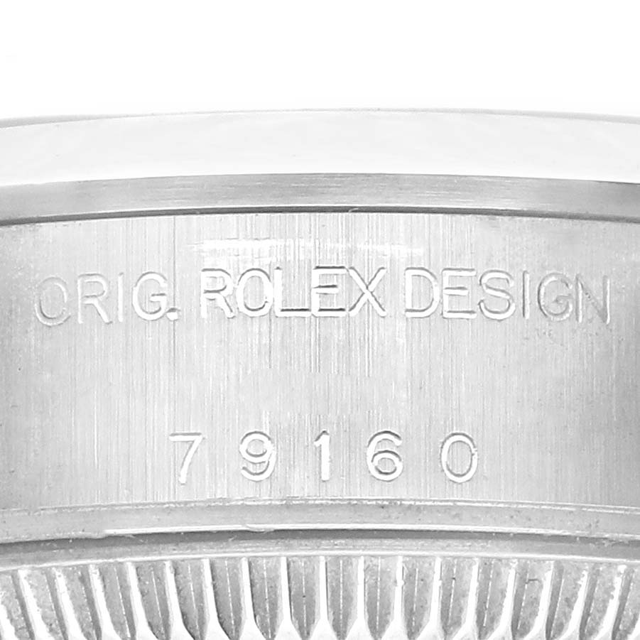 The image shows the side of the Rolex Date 79160 Women's Stainless Steel Pink Dial 79160 Women's Stainless Steel Pink Dial watch case with the model number 79160 and the "ORIG. ROLEX DESIGN" engraving.