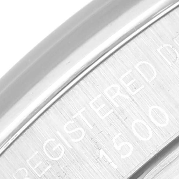 The image shows a close-up angle of the engraved details on the side of a Rolex Vintage Collection 1500 Men's Stainless Steel Grey Dial 1500 Men's Stainless Steel Grey Dial watch.