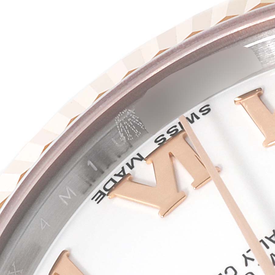 This image shows a close-up of a Rolex Mid-Size 178271 Women
s Steel and Gold (two tone) White Dial 178271 Women
s Steel and Gold (two tone) White Dial model focusing on the bezel and part of the dial with "Swiss Made" visible.