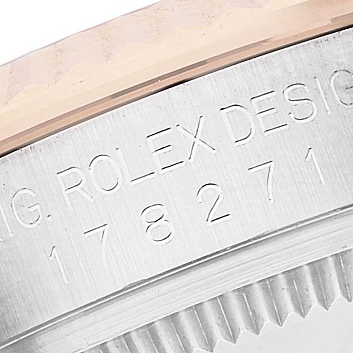 Close-up of the side of a Rolex Mid-Size 178271 Women
s Steel and Gold (two tone) White Dial 178271 Women
s Steel and Gold (two tone) White Dial model, showing the engraving and part of the bezel.