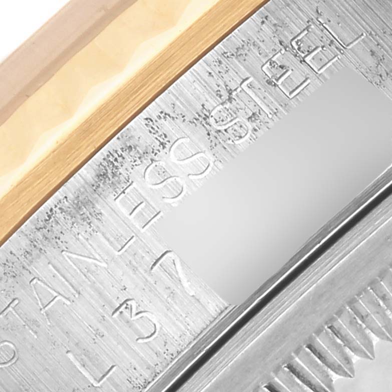 The image shows a close-up of the bezel edge and part of the engraving on a Rolex Datejust 16233 Men's Steel and Gold (two tone) Champagne Dial 16233 Men's Steel and Gold (two tone) Champagne Dial watch.