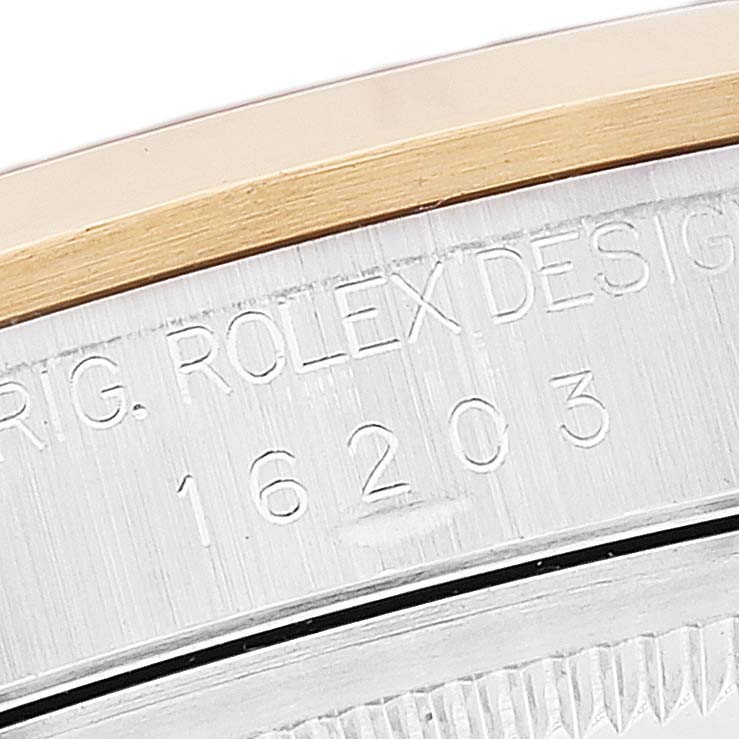 The image shows a close-up of the case side and engraved serial number of a Rolex Datejust 16203 Men's Steel and Gold (two tone) Champagne Dial 16203 Men's Steel and Gold (two tone) Champagne Dial 16203.