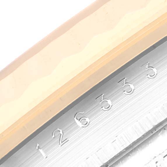 This image shows a close-up of the engraved serial numbers on the inner bezel of a Rolex Datejust 41 126333 Men's Steel and Gold (two tone) Black Dial 126333 Men's Steel and Gold (two tone) Black Dial watch.