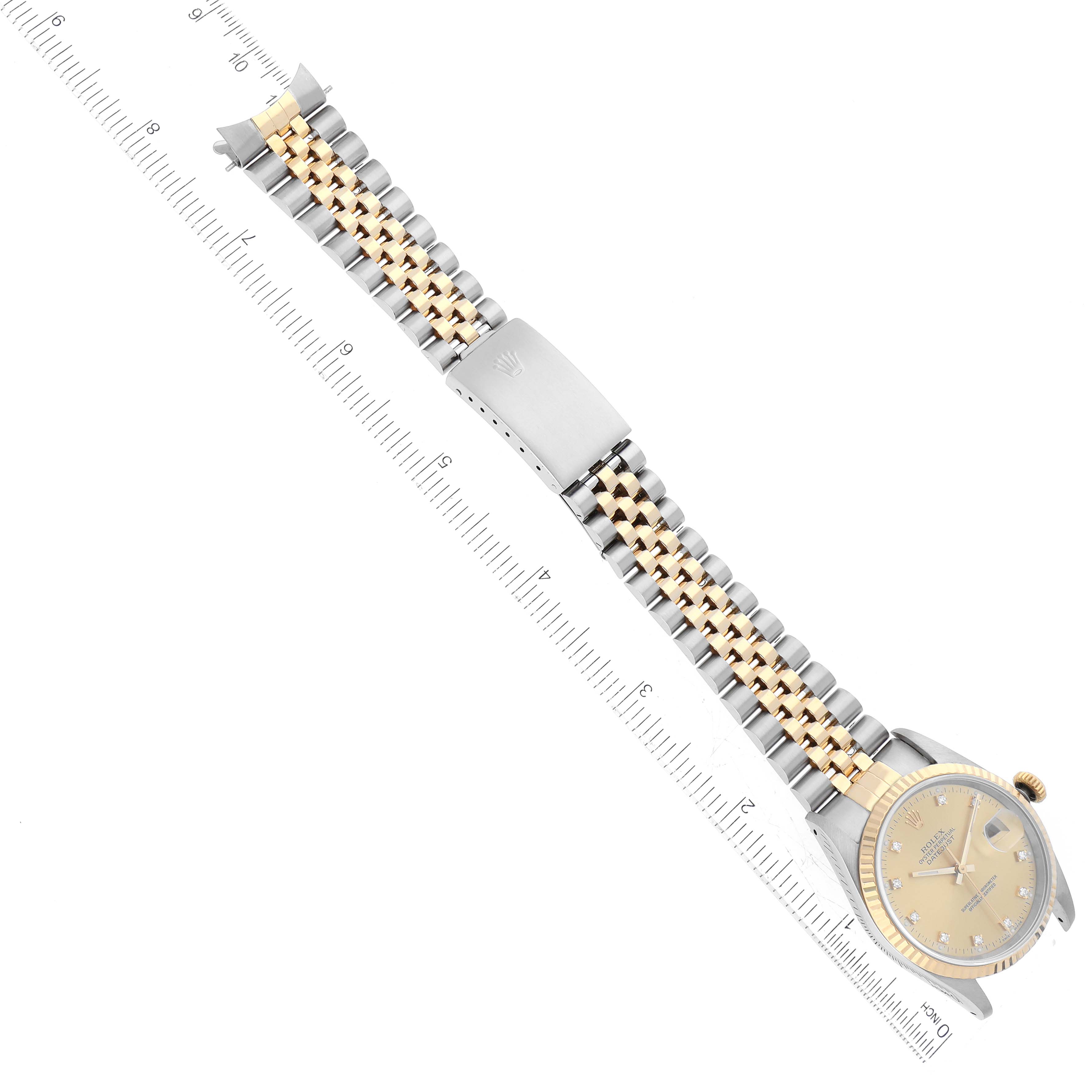 This image shows the Rolex Datejust 16233 Men's Steel and Gold (two tone) Champagne Dial 16233 Men's Steel and Gold (two tone) Champagne Dial watch from an overhead angle, featuring the dial, case, and two-tone bracelet with a ruler for scale.