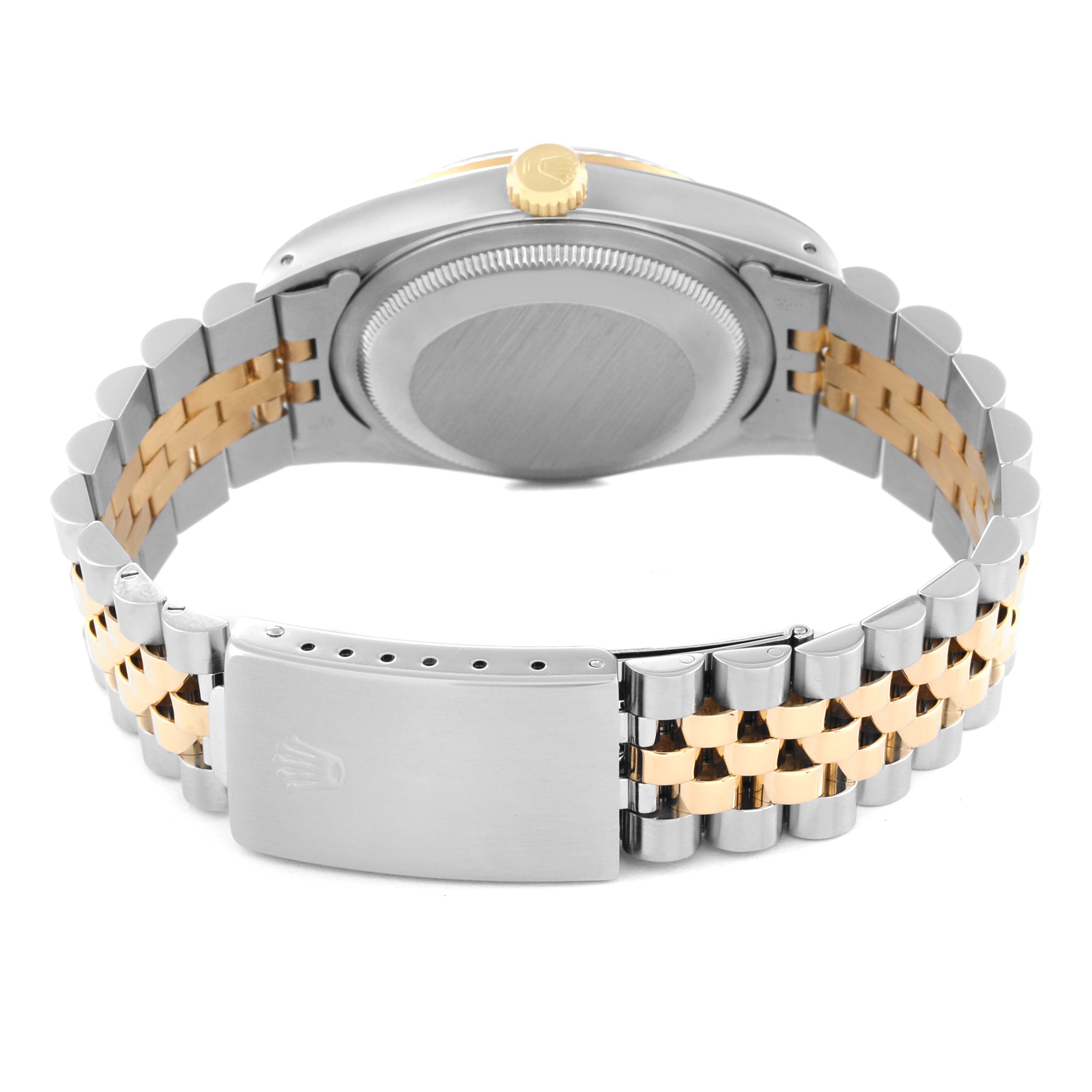 This image shows the backside of a Rolex Datejust 16233 Men's Steel and Gold (two tone) Champagne Dial 16233 Men's Steel and Gold (two tone) Champagne Dial watch, focusing on its case, crown, and two-tone bracelet with the clasp.