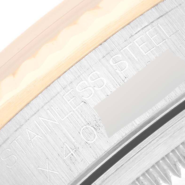 This image shows a close-up of the stainless steel casing edge of a Rolex Datejust 16233 Men's Steel and Gold (two tone) Champagne Dial 16233 Men's Steel and Gold (two tone) Champagne Dial watch.
